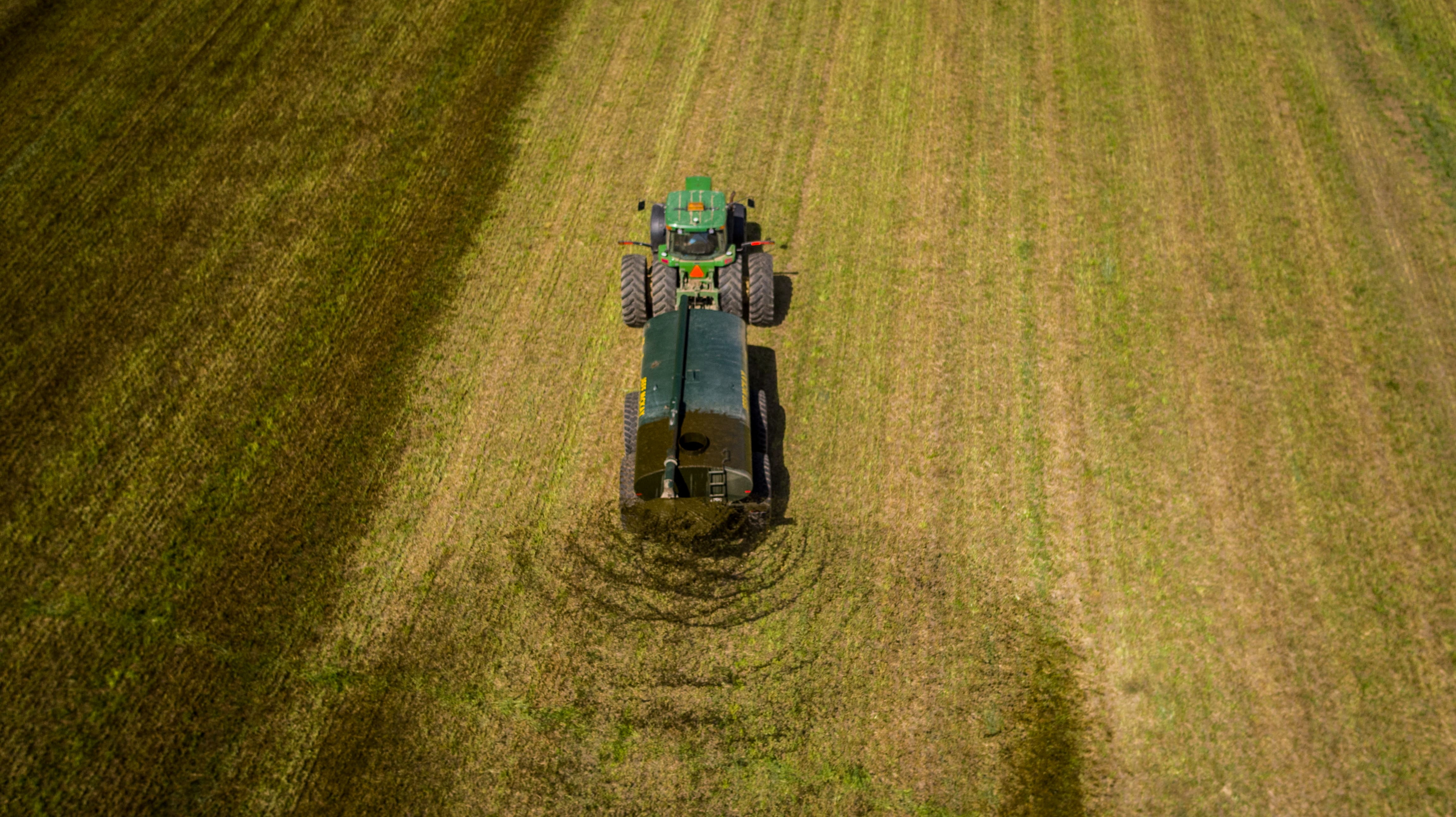 A custom hauler spreads dairy manure on hay ground in Wallenstein, Ontario
