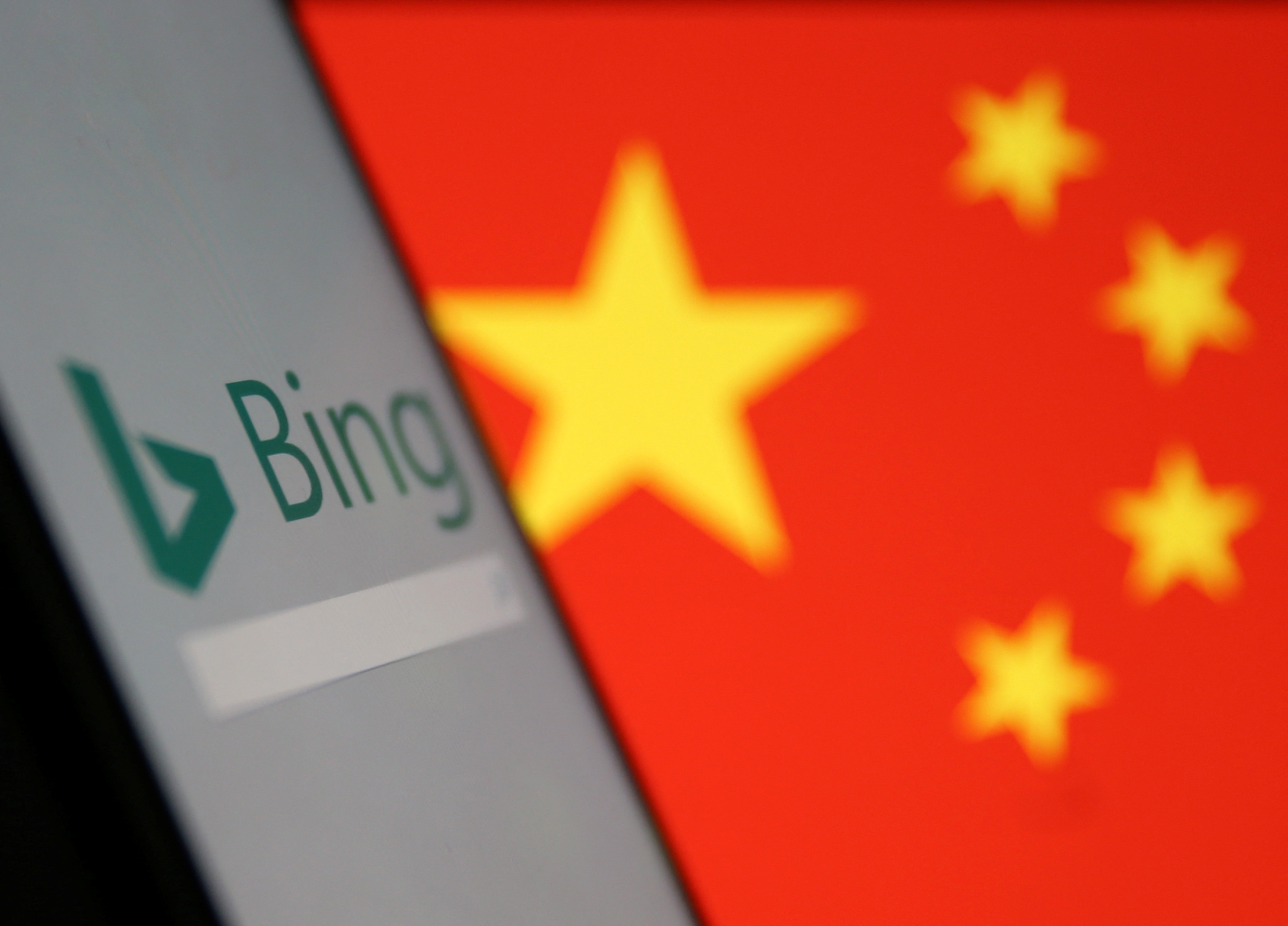 A smartphone with the Microsoft Bing logo is displayed against the backdrop of a Chinese flag in this picture illustration
