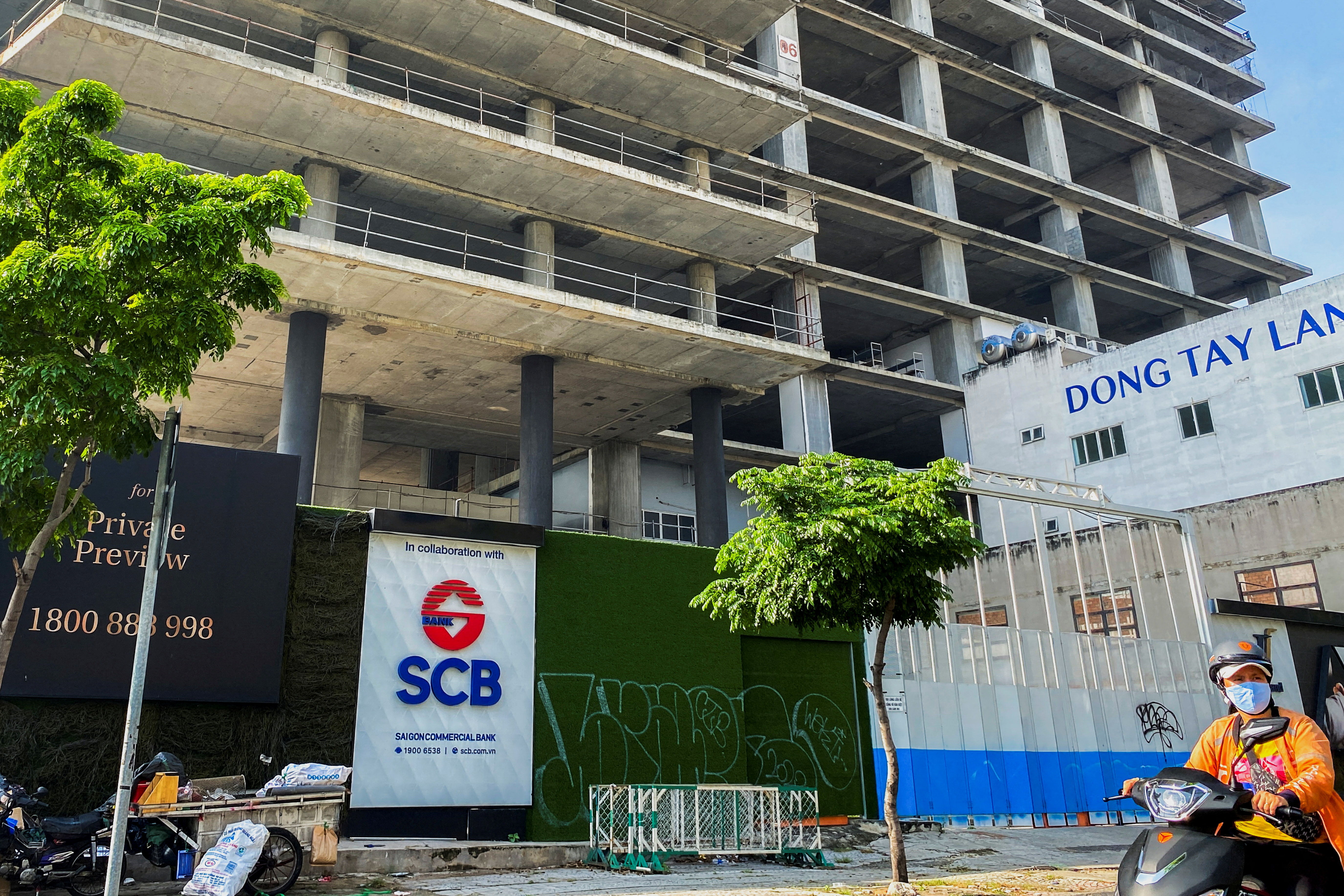 A logo of Saigon Joint Stock Commercial Bank (SCB) is seen in front of an under-construction building in Ho Chi Minh City