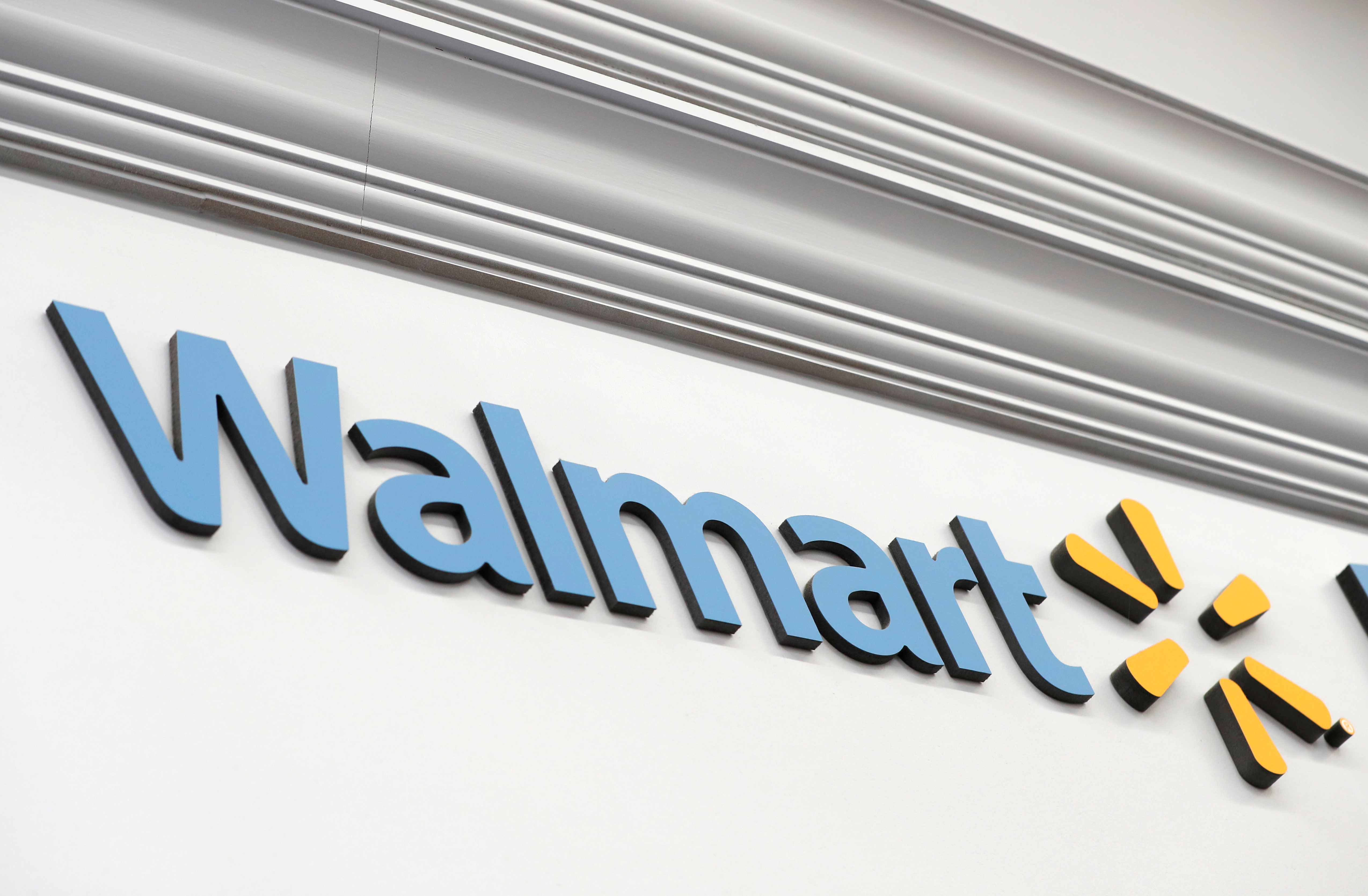 A Walmart sign is seen inside its department store in West Haven, Connecticut, U.S., February 17, 2021. REUTERS/Mike Segar/File Photo