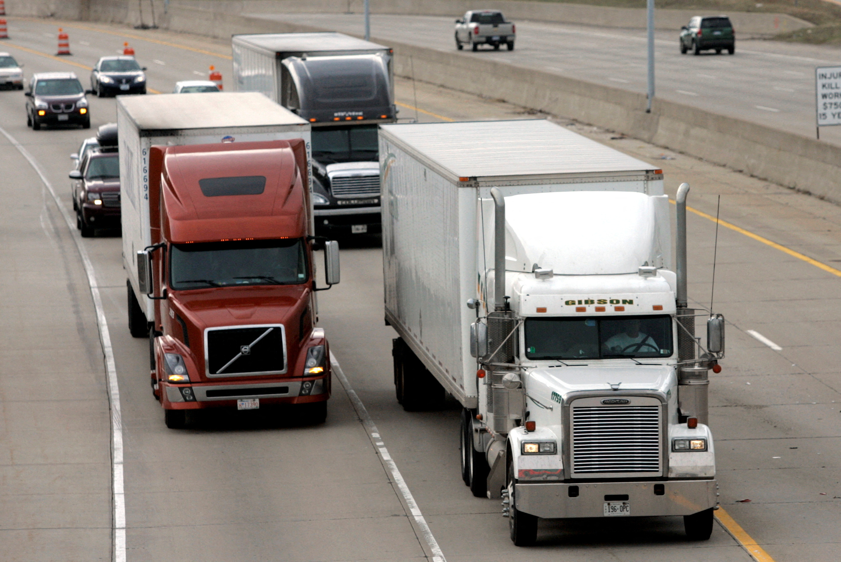 Two freight trucks are driven on a freeway in Detroit, Michigan