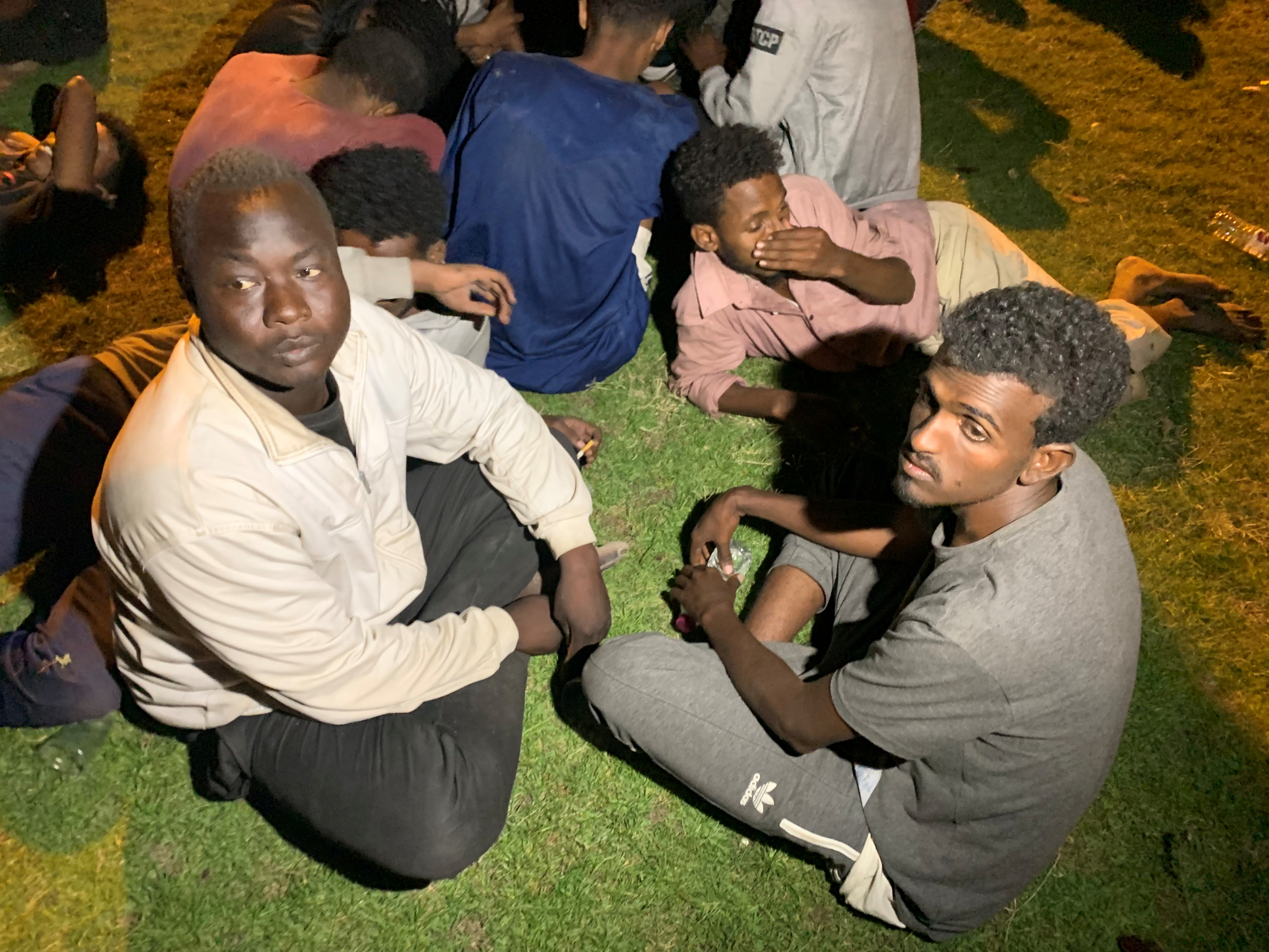 Migrants are seen after they were detained by Libyan security forces in Tripoli