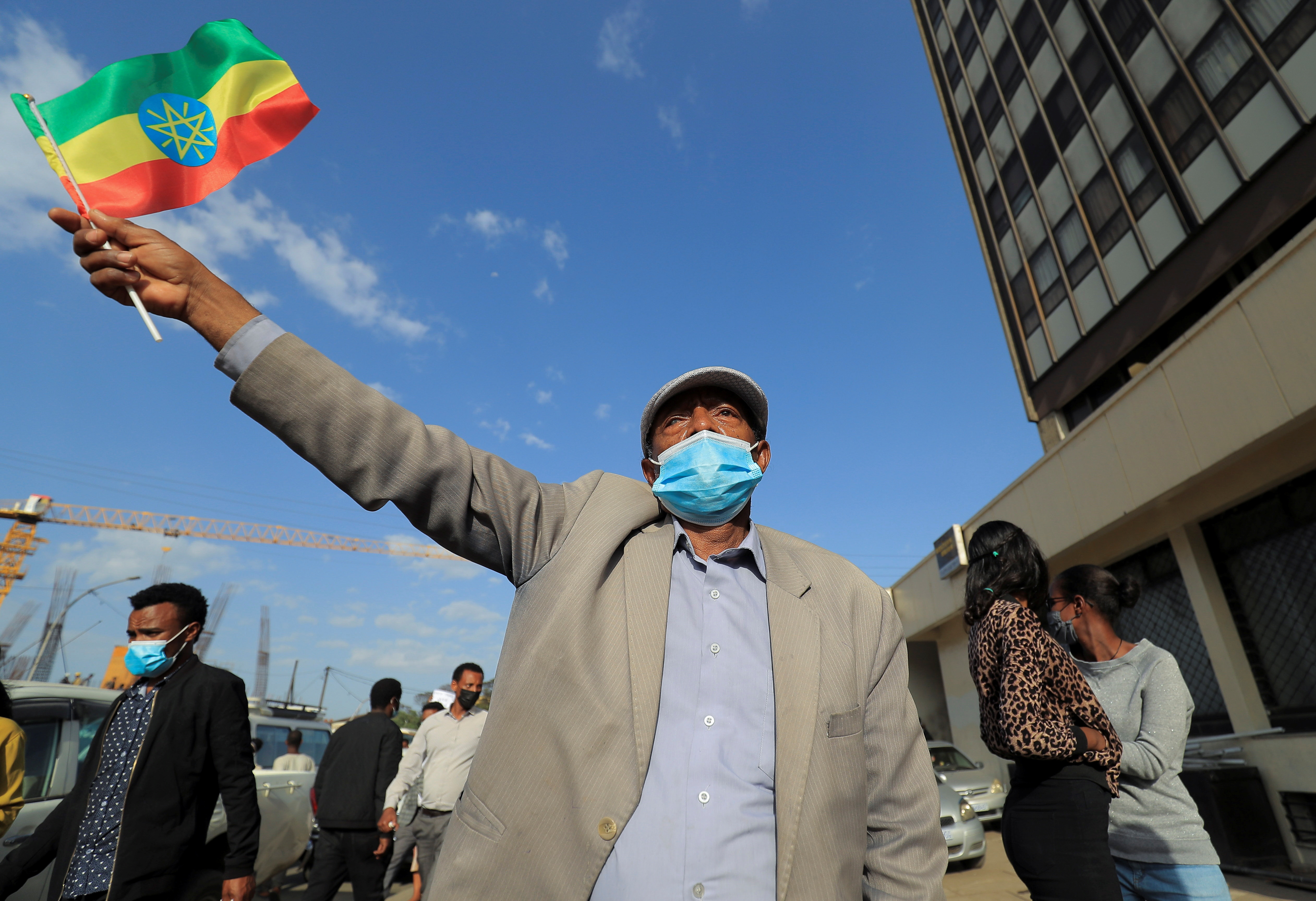 A man holds a national flag during a protest by people describing themselves as patriotic Ethiopians demonstrating against perceived interference by the western countries in their internal affairs in Addis Ababa