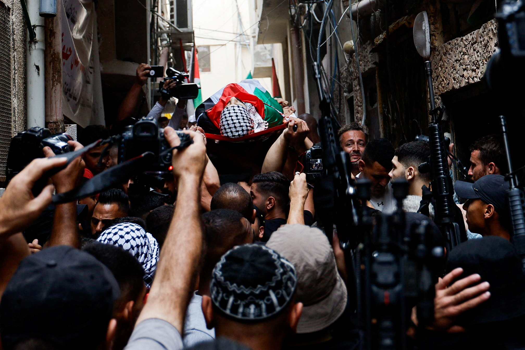 Mourners attend the funeral of Palestinian Naem Farran who was killed in an Israeli raid, near Nablus
