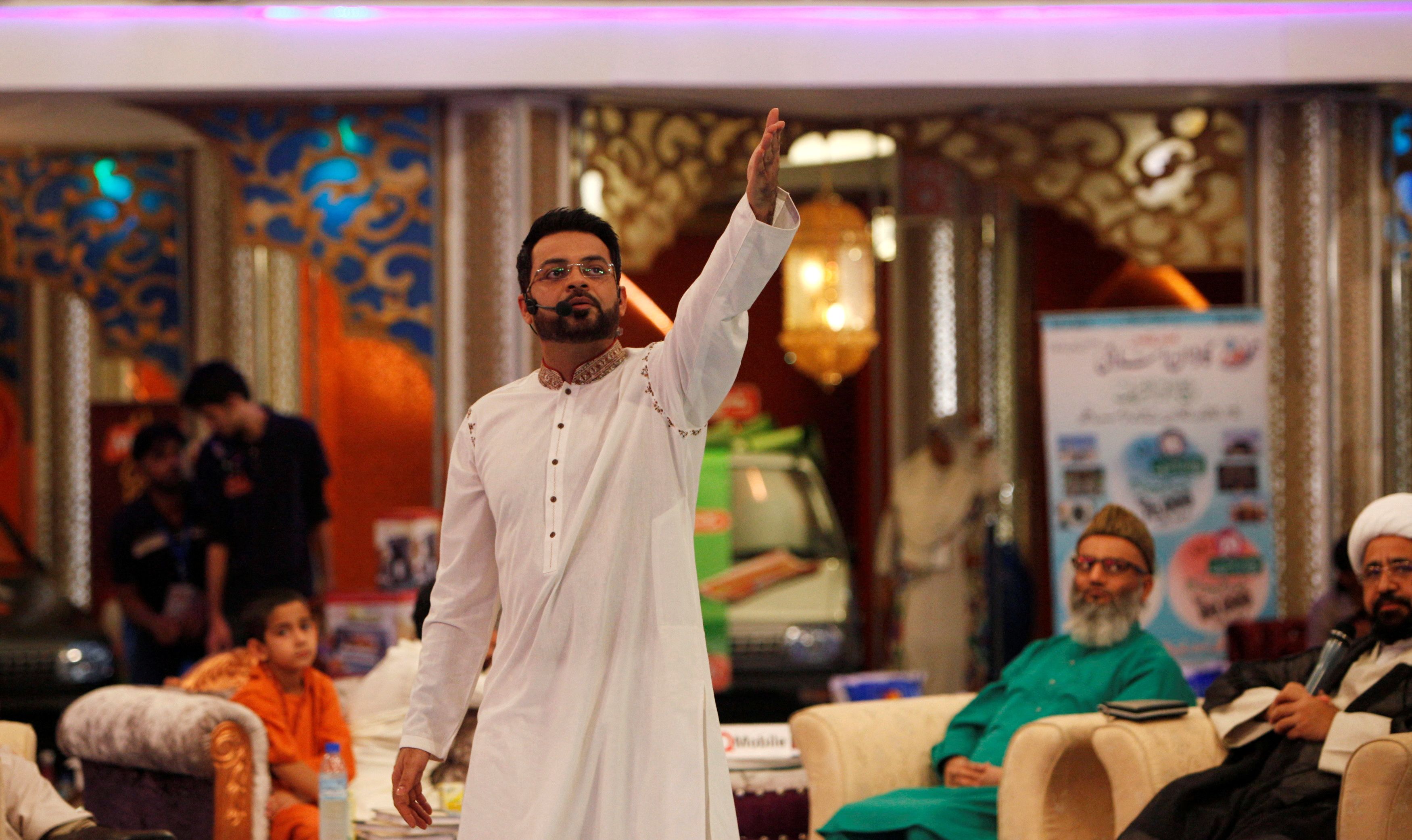 Hussain, host of the Geo TV channel programme "Amaan Ramazan", gestures during a live show in Karachi