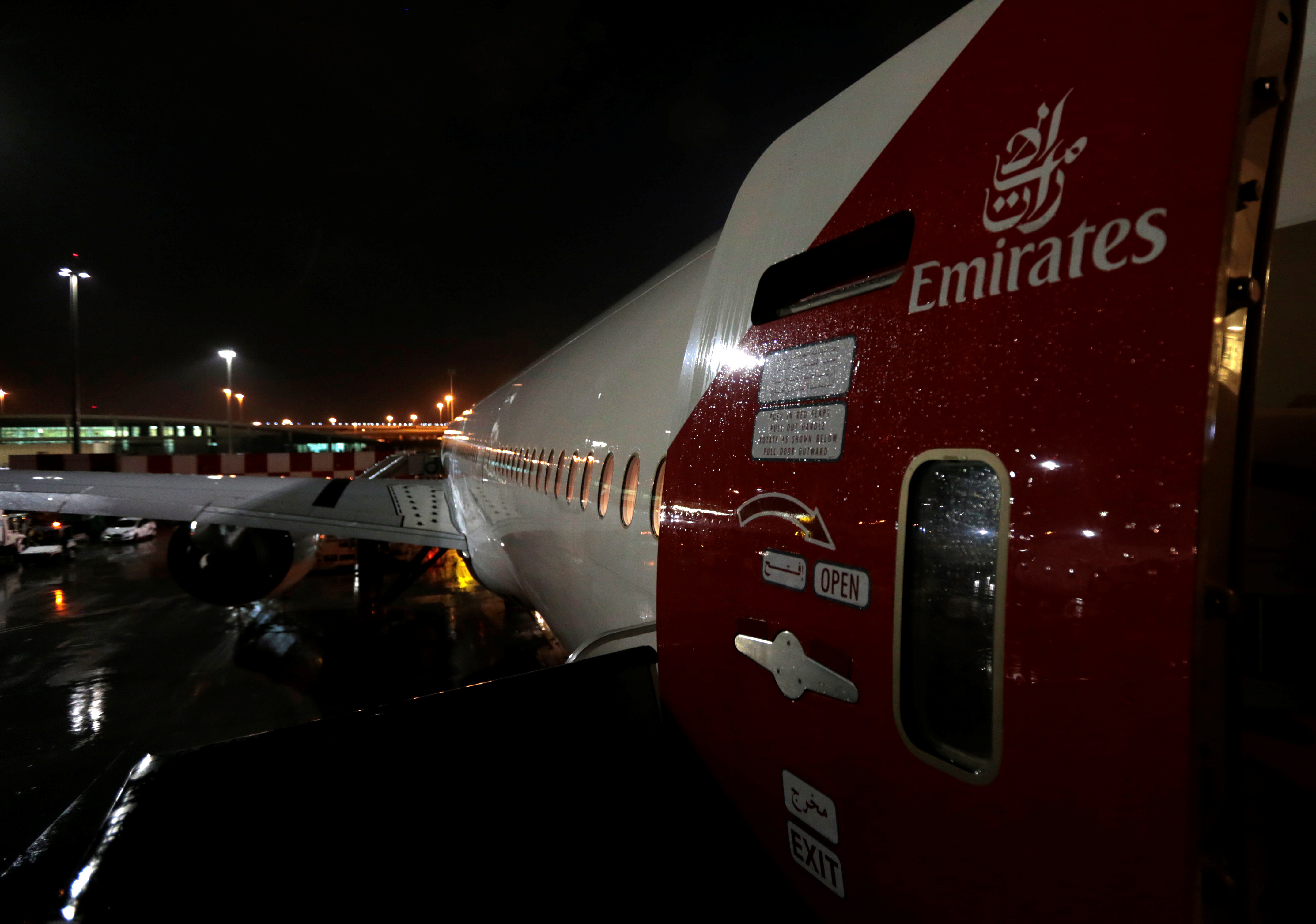 The Emirates airlines logo is seen on the back door of a plane at Dubai International Airport