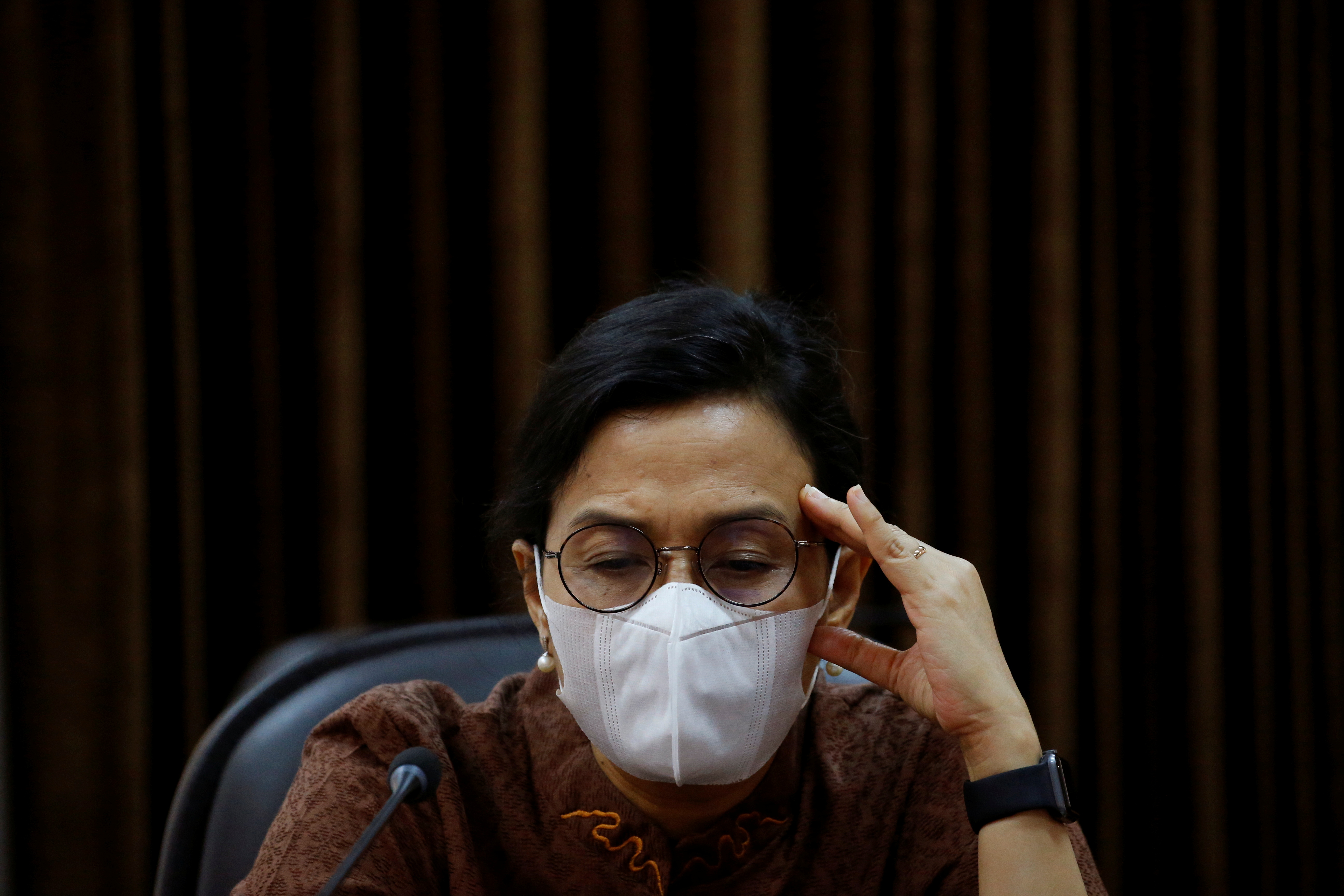 Indonesian Finance Minister Sri Mulyani wearing a protective mask reacts during an interview with Reuters at the Presidential Palace in Jakarta