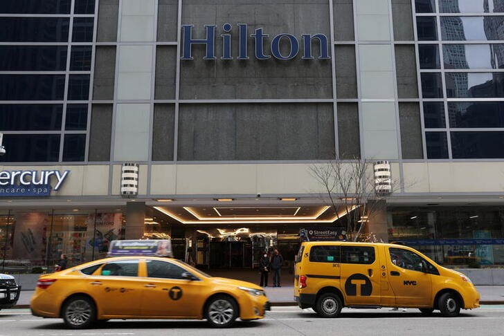 Taxi cabs drive by a Hilton hotel in Manhattan, New York City