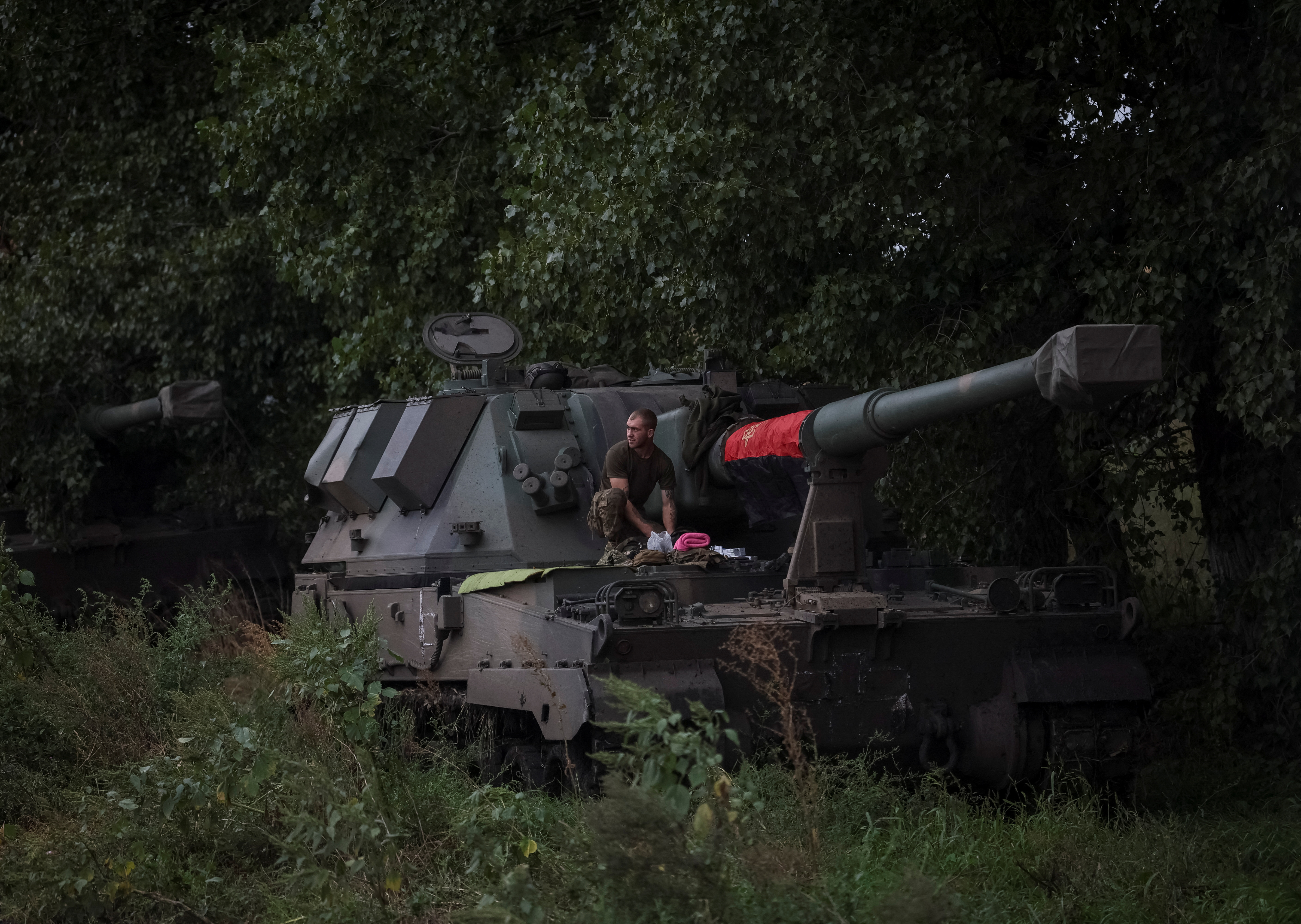 Ukrainian serviceman stands at a Polish self-propelled howitzer Krab