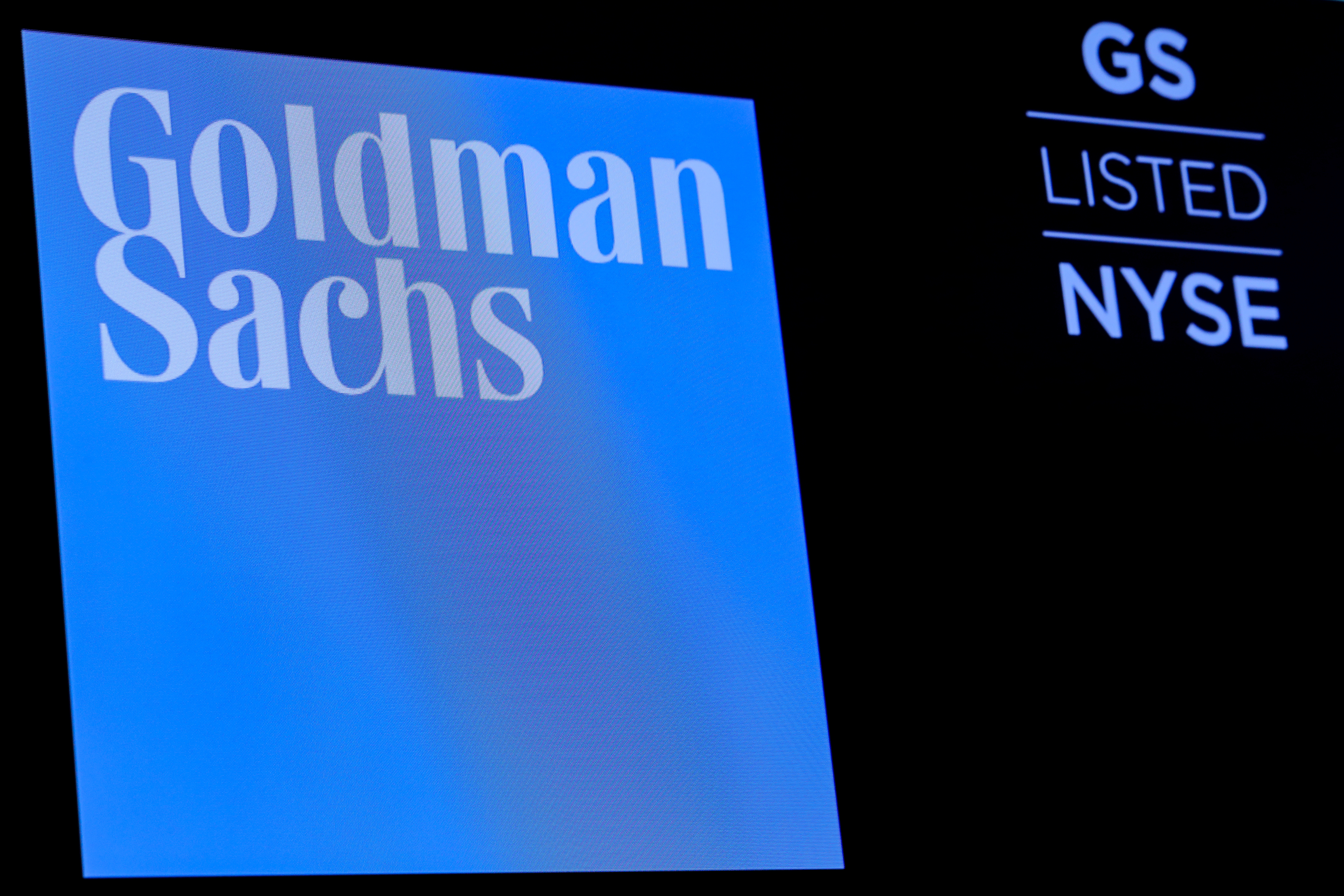 The ticker symbol and logo for Goldman Sachs is displayed on a screen on the floor at the NYSE in New York