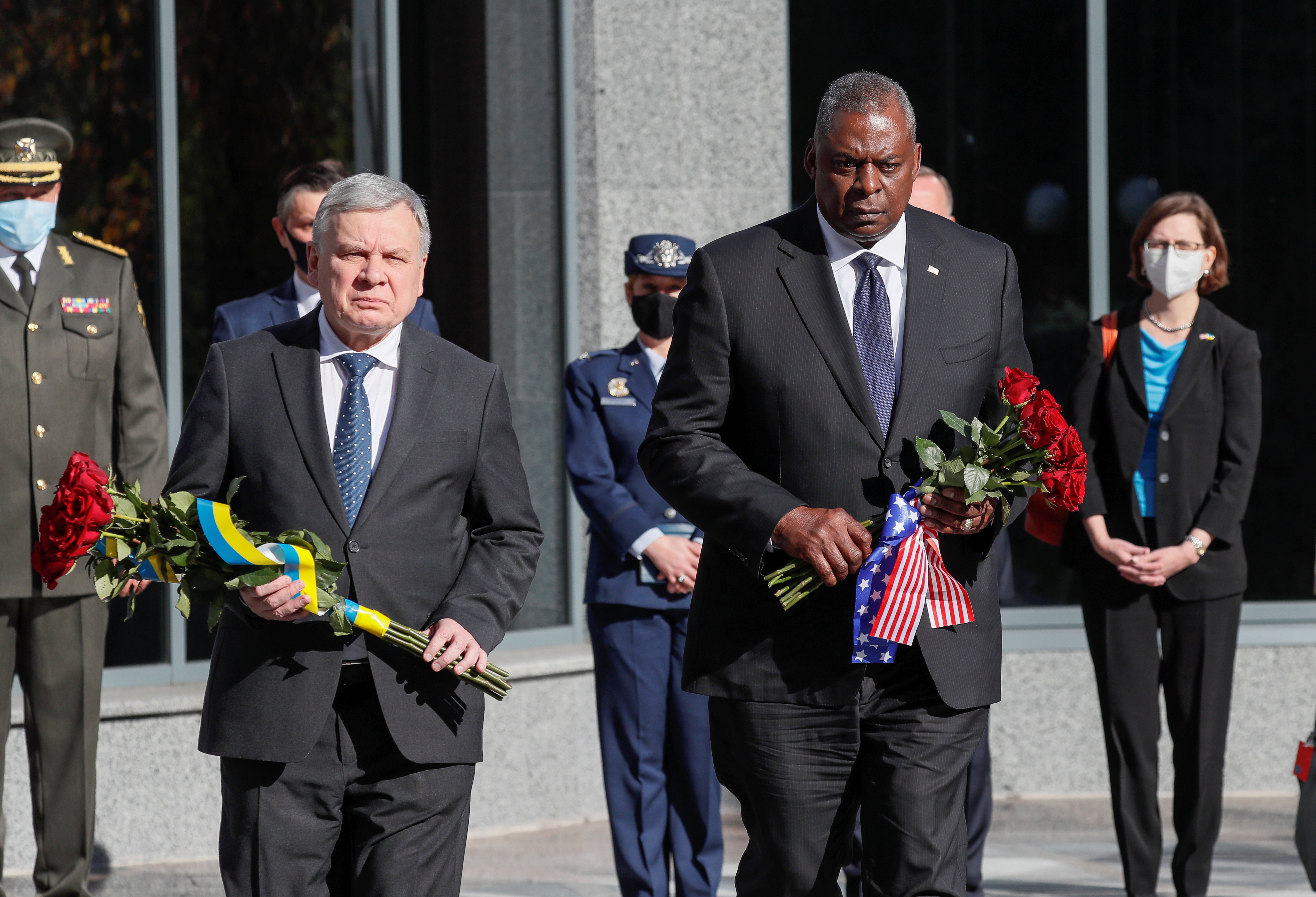 U.S. Defense Secretary Lloyd Austin and Ukrainian Defence Minister Andriy Taran visit a pantheon commemorating fallen defenders of Ukraine prior to their meeting in Kyiv, Ukraine October 19, 2021. REUTERS/Gleb Garanich