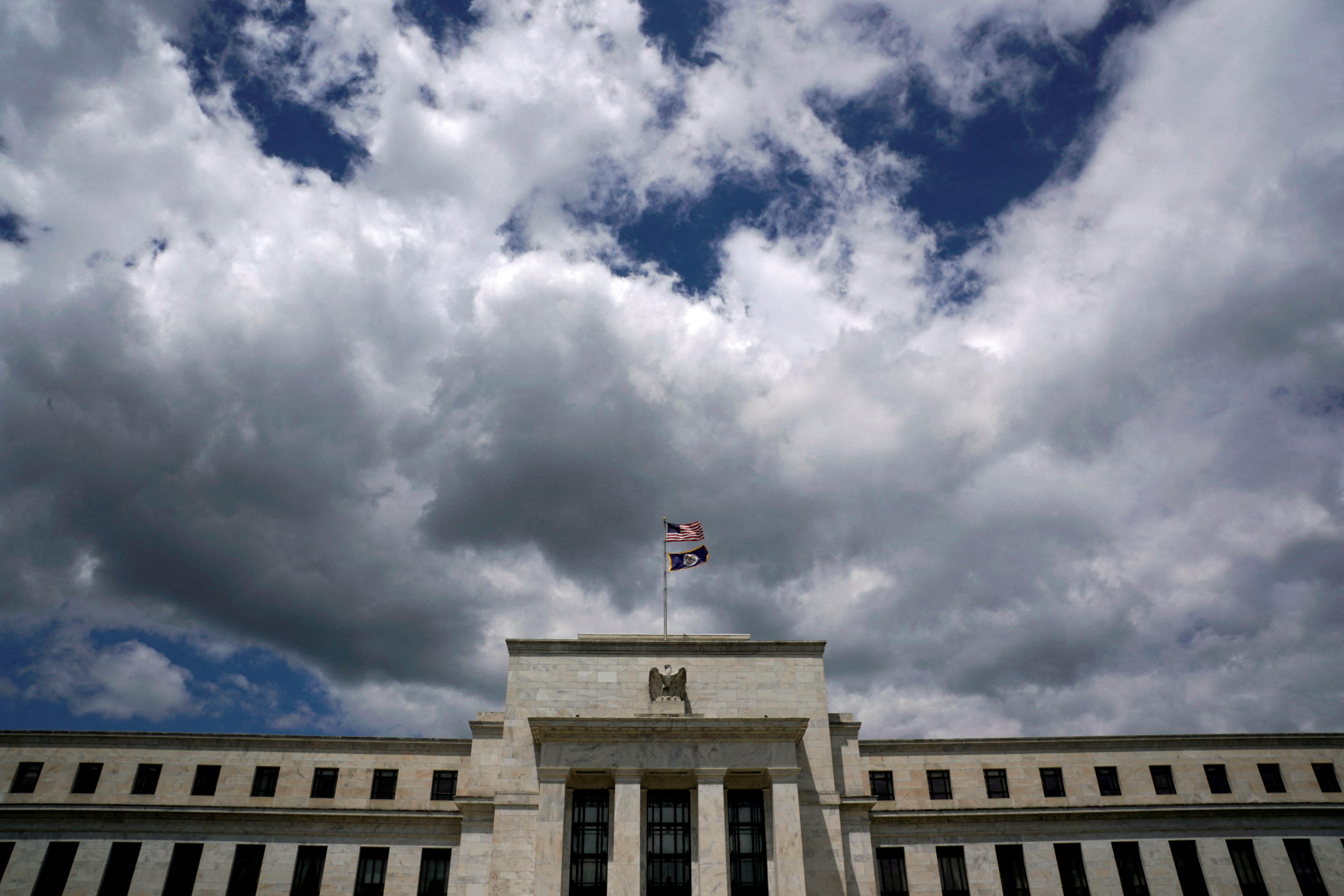 Flags fly over the Federal Reserve Headquarters on a windy day in Washington, U.S., May 26, 2017. REUTERS/Kevin Lamarque/File Photo