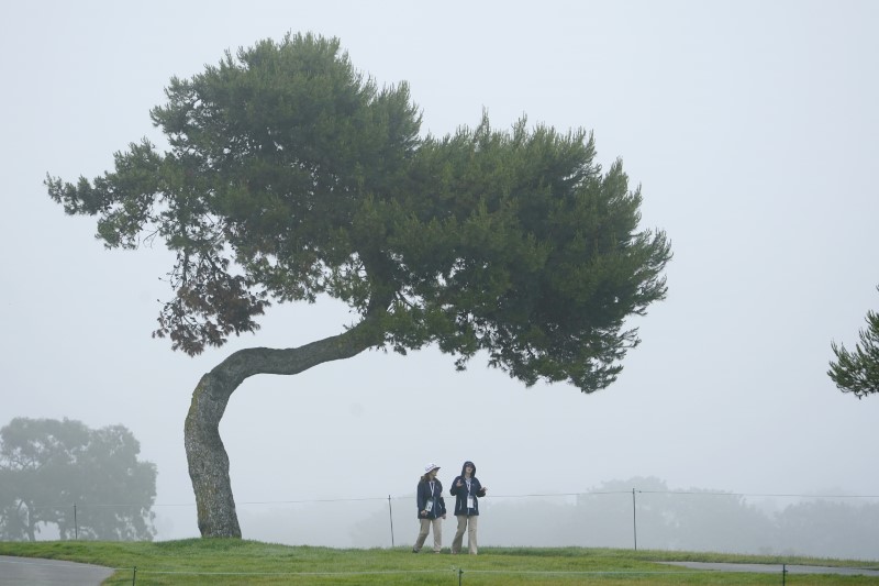 Jun 17, 2021; San Diego, California, USA; Volunteers walk along the 6th fairway in the fog during the first round of the U.S. Open golf tournament at Torrey Pines Golf Course. Mandatory Credit: Michael Madrid-USA TODAY Sports