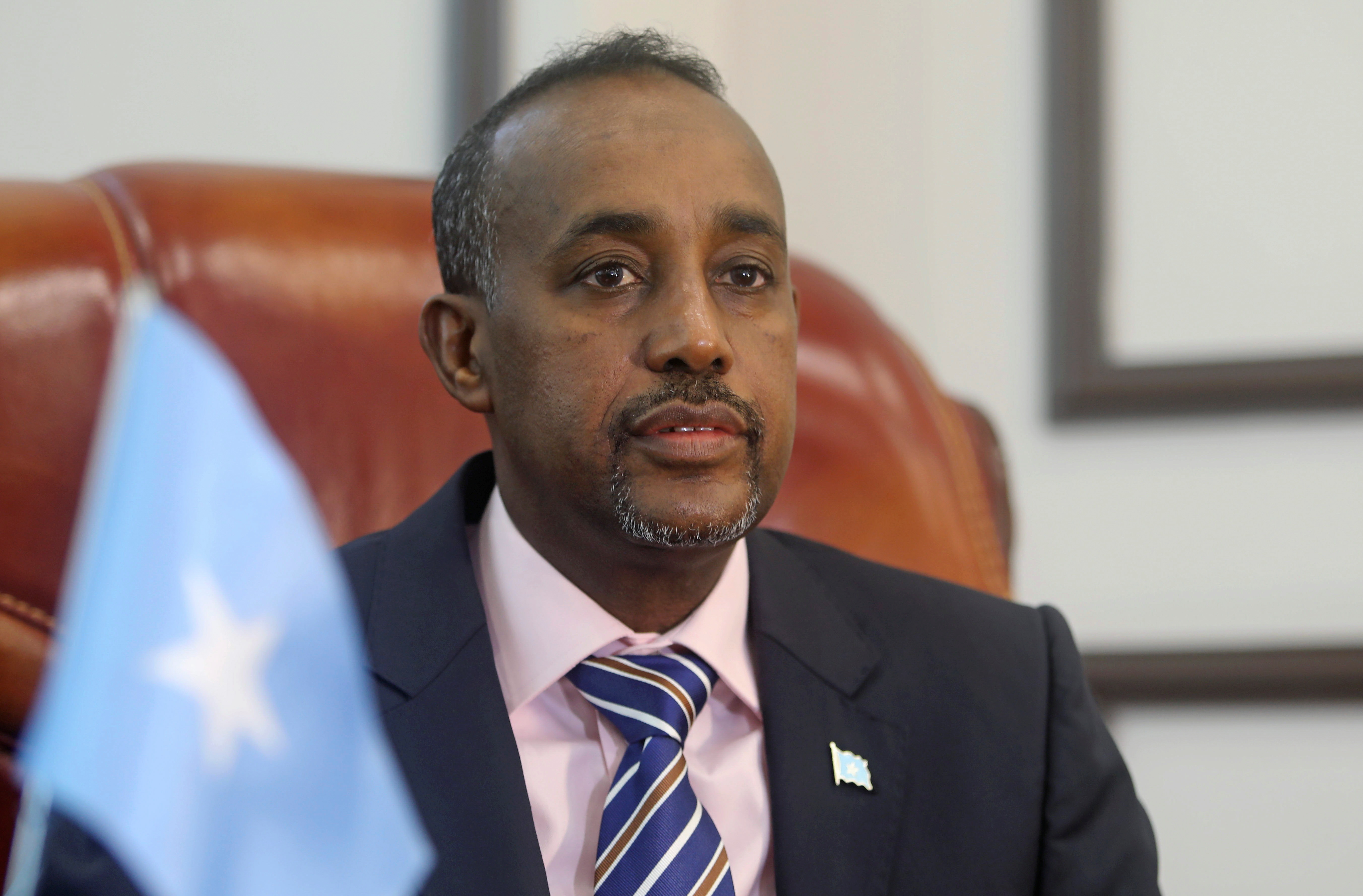 Somalia's PM Mohamed Hussein Roble looks on before addressing members of parliament, in Mogadishu