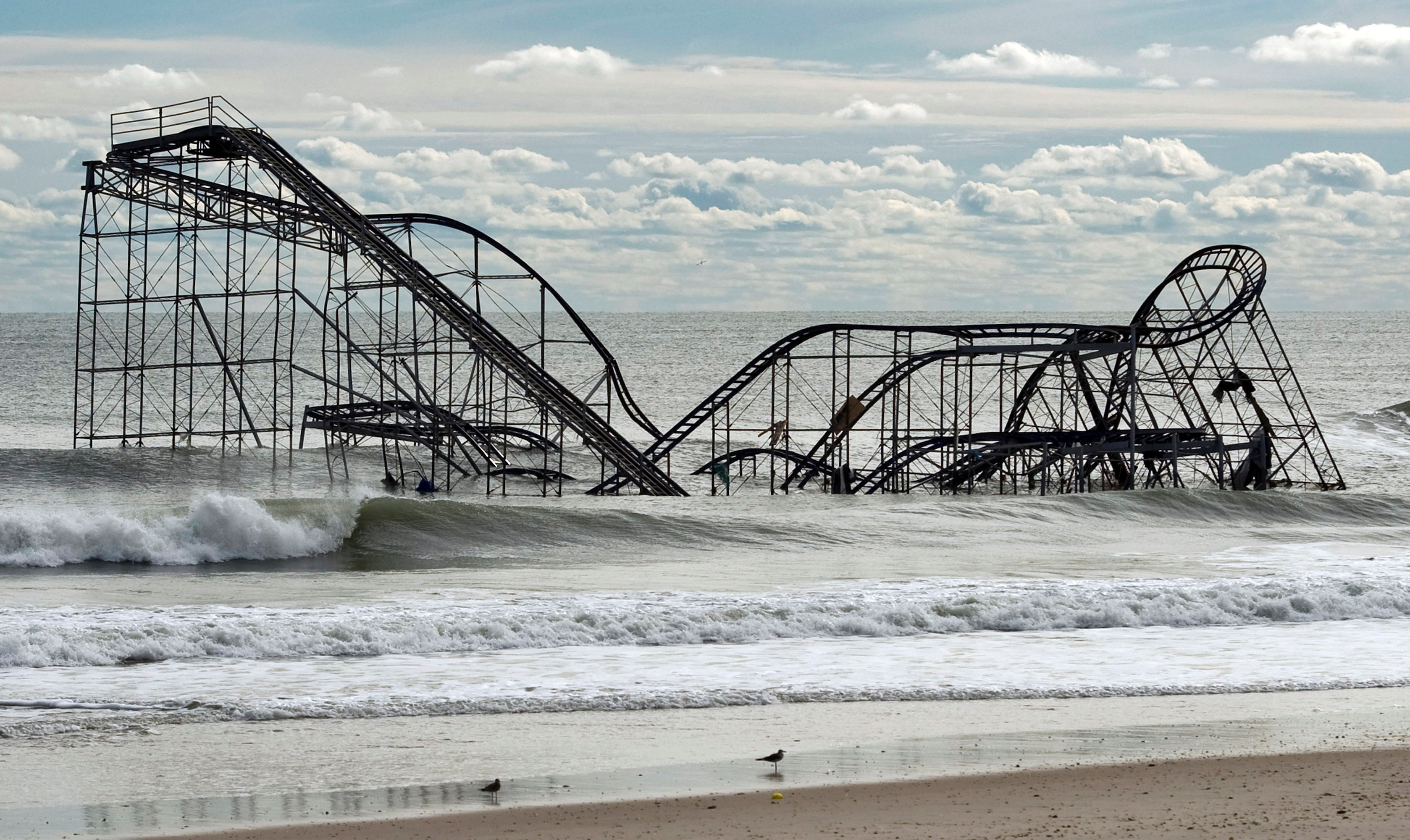 The remnants of a roller coaster sits in the surf three days after Hurricane Sandy came ashore in Seaside Heights, New Jersey November 1, 2012. REUTERS/Steve Nesius/File Photo