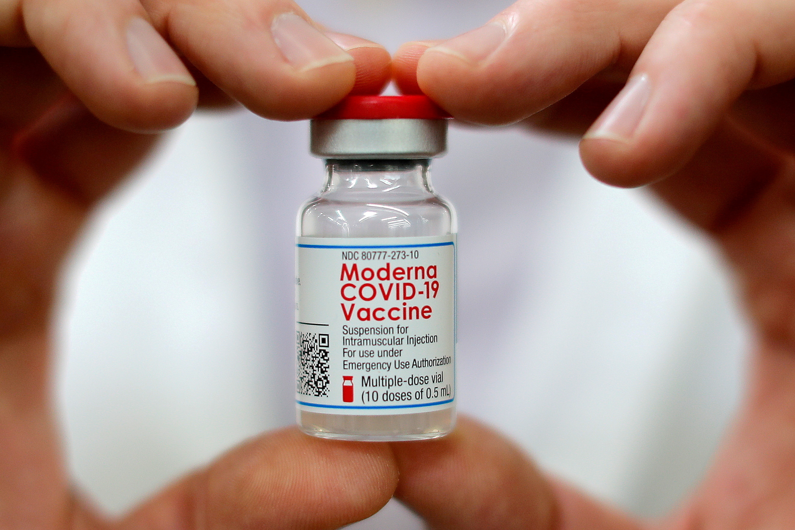 Walmart pharmacist holds a vial of the Moderna coronavirus disease (COVID-19) vaccine inside a Walmart department store in West Haven, Connecticut, U.S., February 17, 2021.