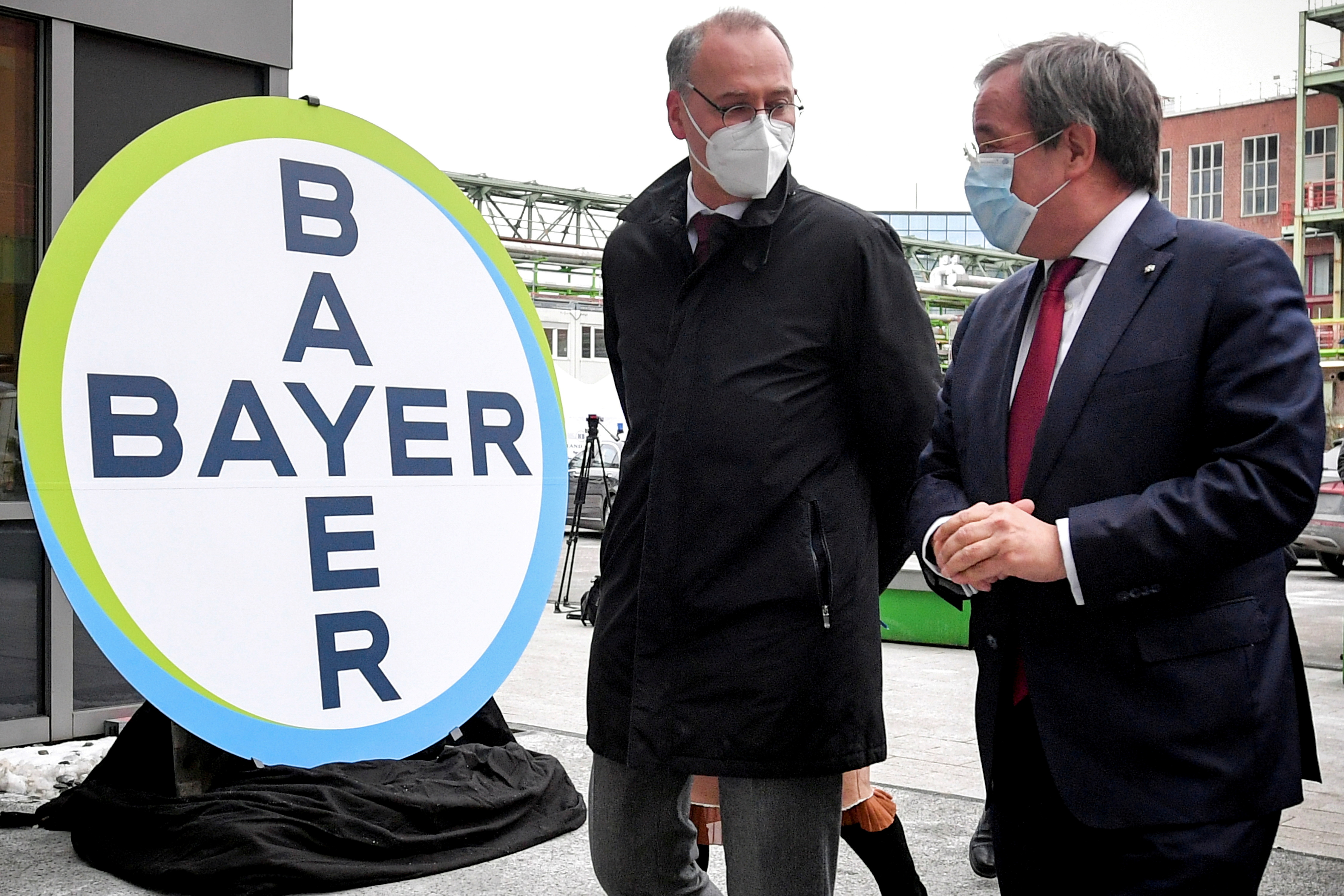 Prime Minister of North Rhine-Westphalia Armin Laschet and Werner Baumann, CEO of German pharmaceutical company Bayer AG, speak to the media following their visit to the future production site of CureVac's COVID-19 vaccine (CVnCoV) at the Bayer AG plant in Wuppertal, Germany February 15, 2021. Sascha Steinbach/Pool via REUTERS/File Photo