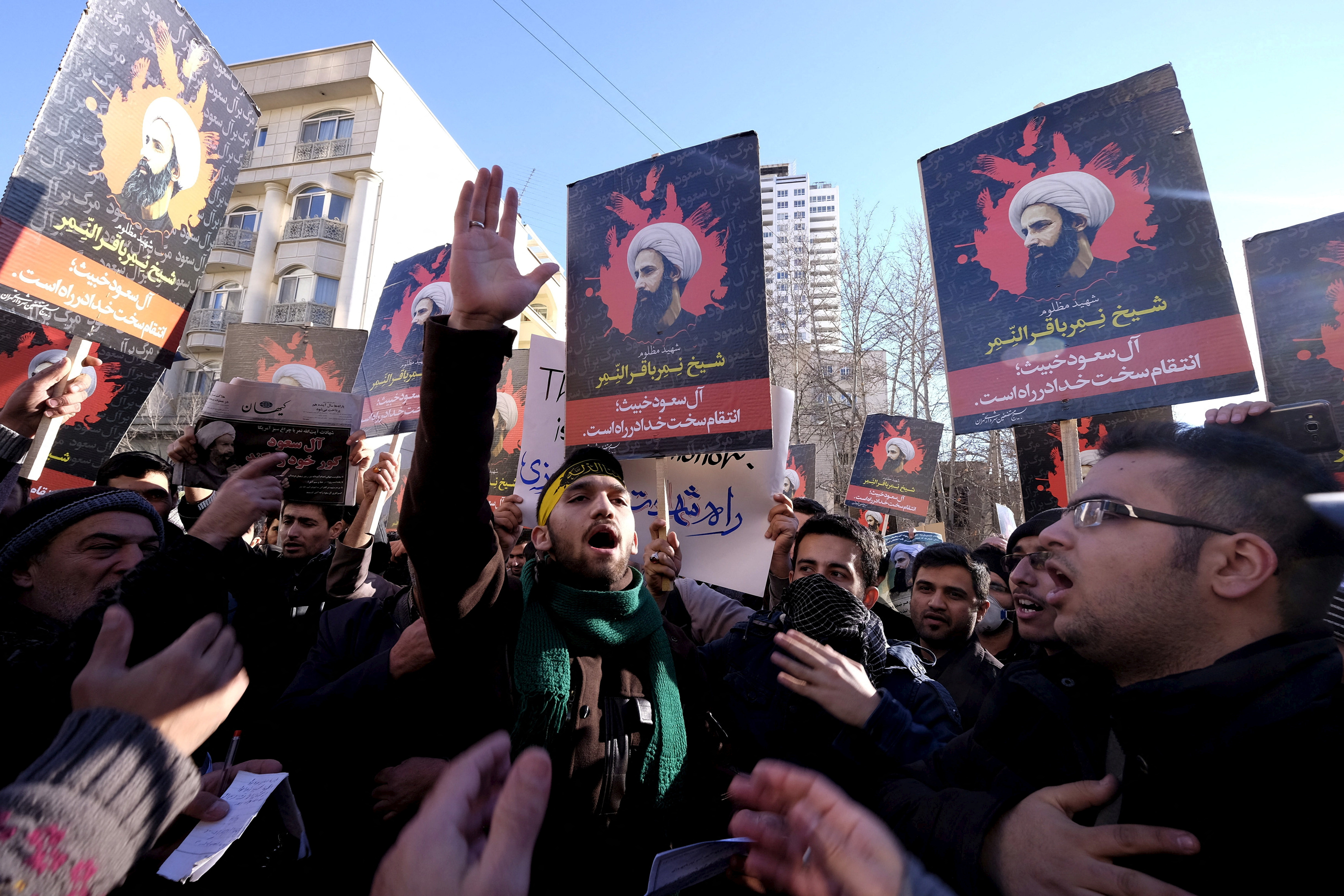Iranian protesters chant slogans as they hold pictures of Shi'ite cleric Sheikh Nimr al-Nimr during a demonstration against the execution of Nimr in Saudi Arabia, outside the Saudi Arabian Embassy in Tehran
