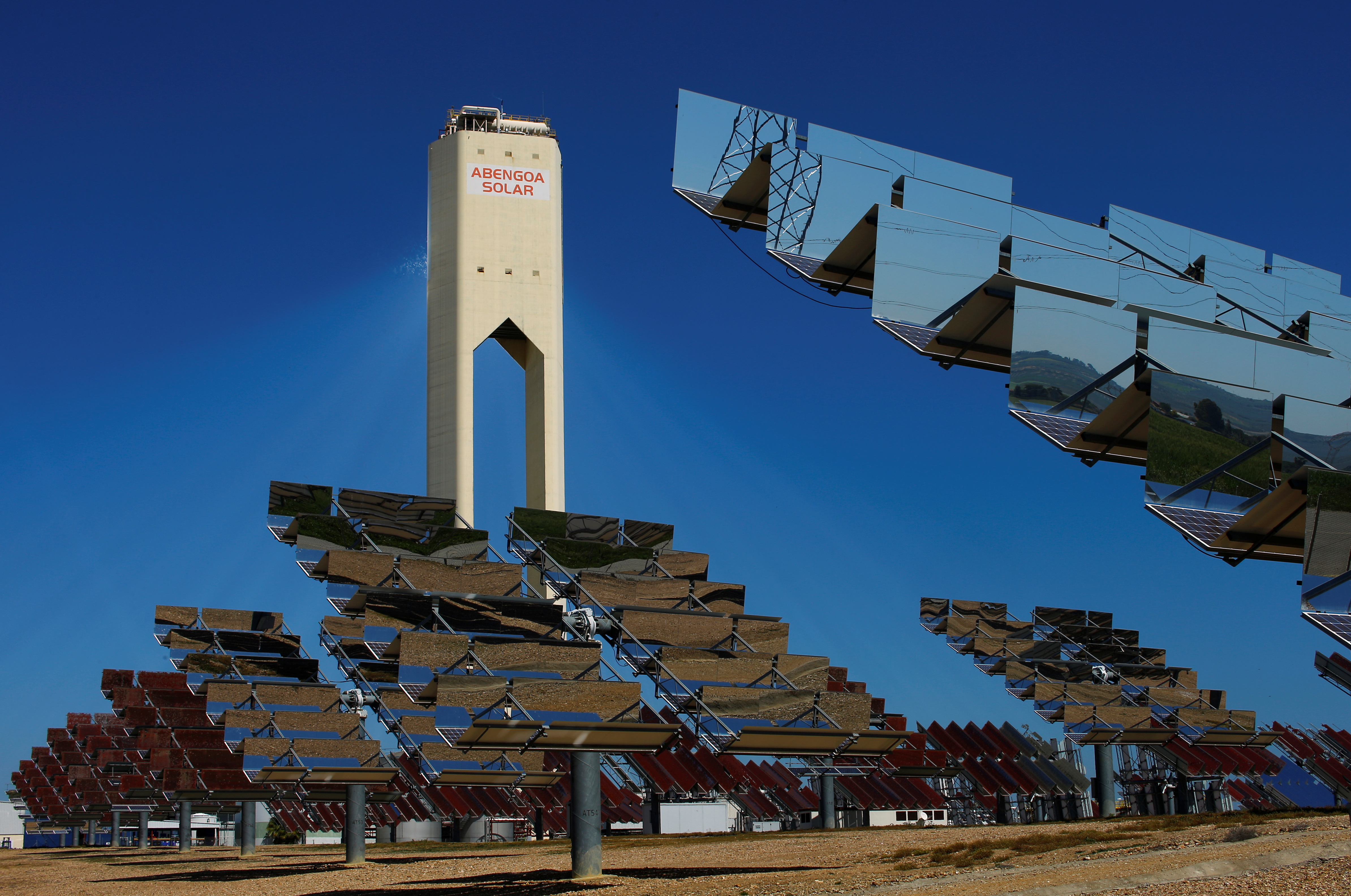 A tower and solar panels belonging to Abengoa are seen at the Solucar solar park in Sanlucar la Mayor