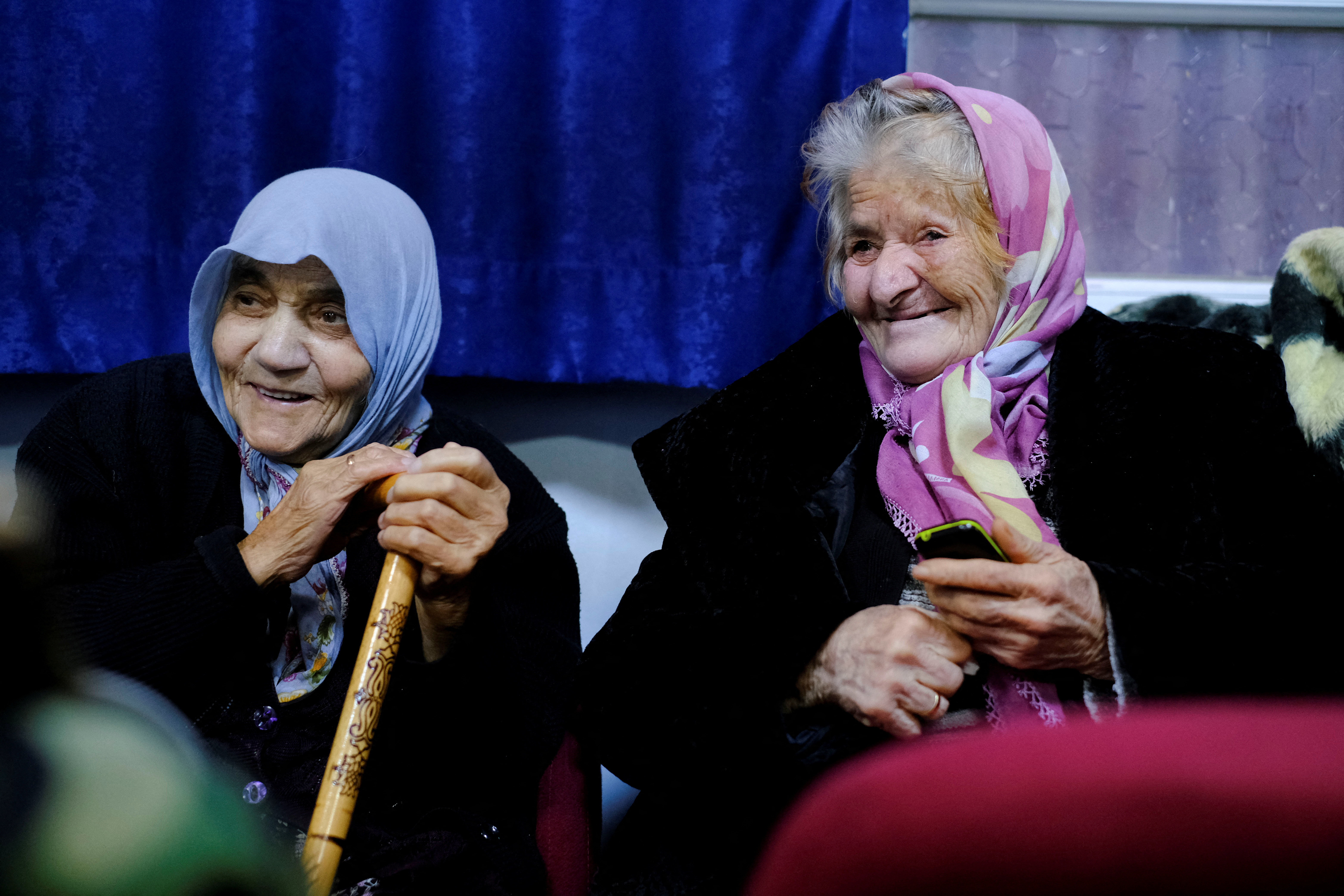 Two elderly Turkish women sit in a school-turned-shelter in Adana, Turkey