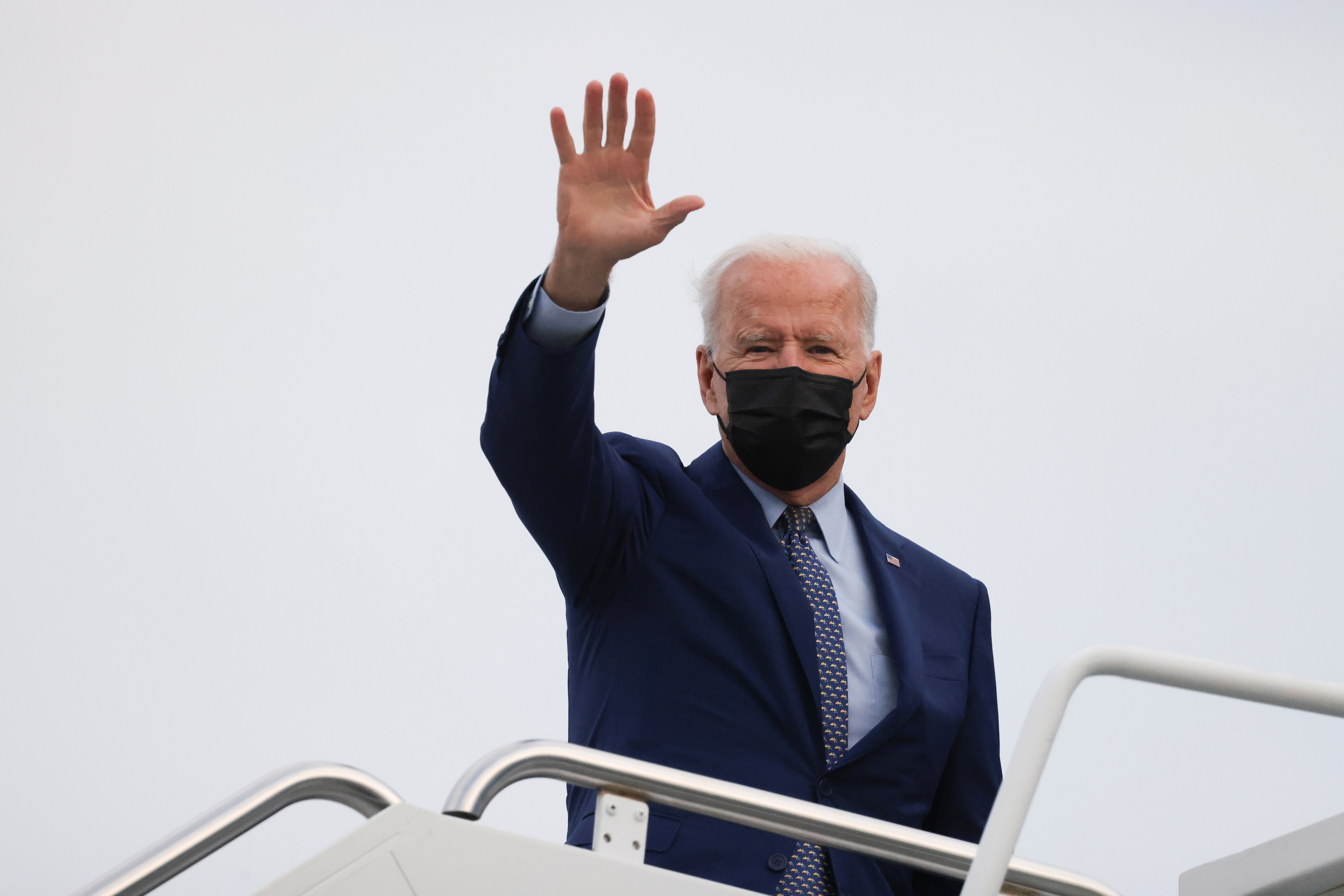U.S. President Joe Biden waves as he boards Air Force One after attending the Democratic National Committee's 