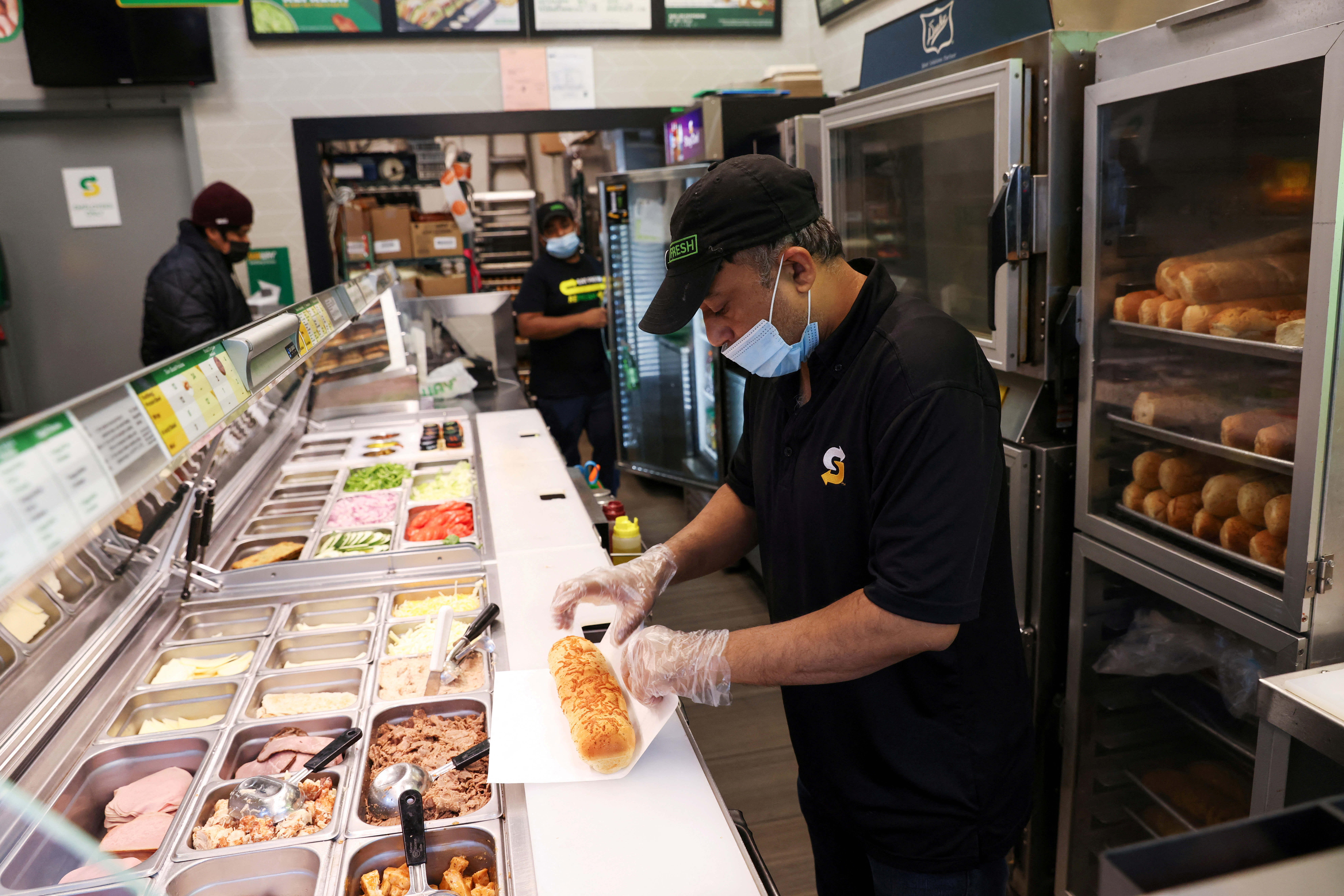 Servers work at a Subway restaurant in Manhattan, New York City