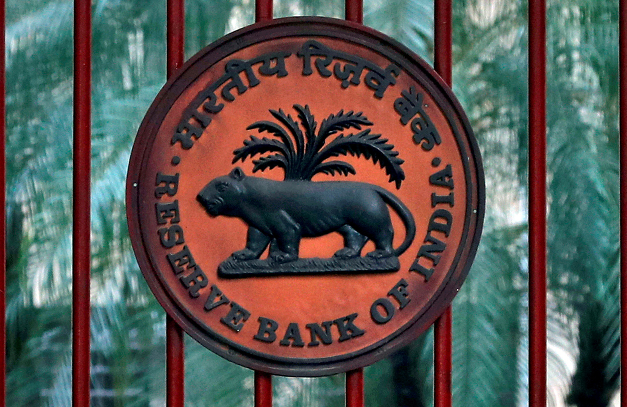 Reserve Bank of India logo is seen at the gate of its office in New Delhi