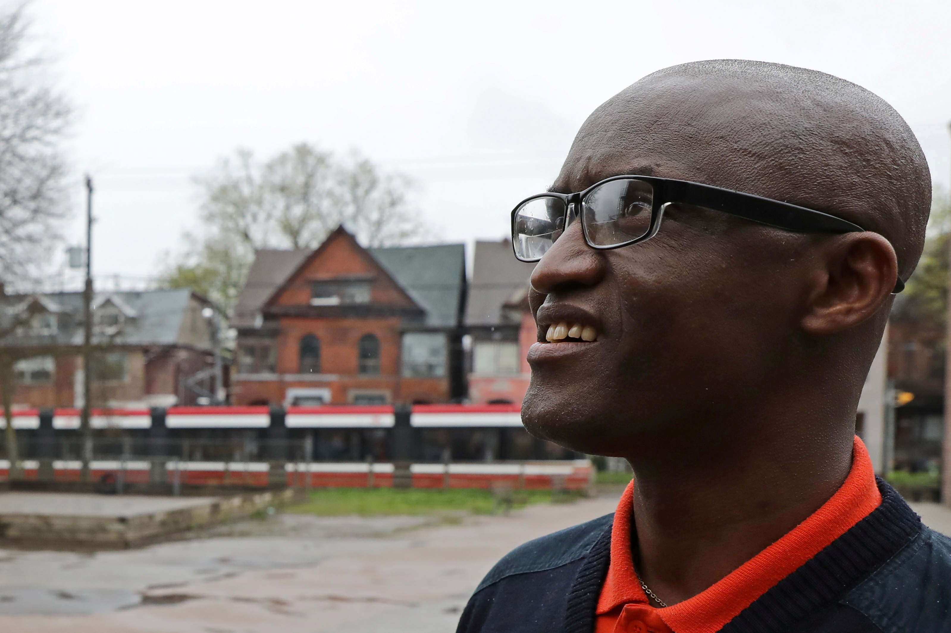 Apollinaire Nduwimana poses outside a school near his lodging in Toronto