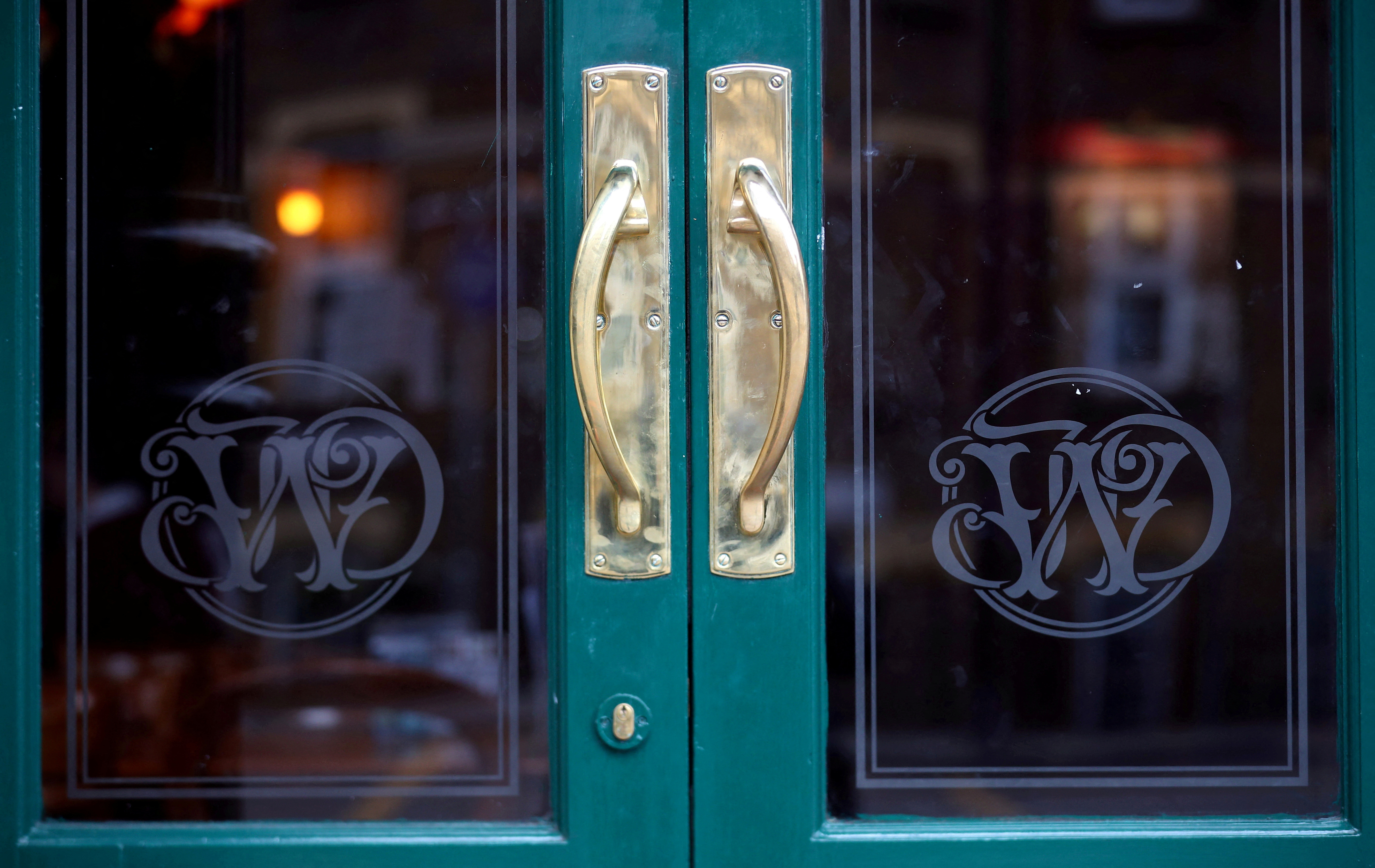 Wetherspoon's logos are seen at the entrance to a pub in central London