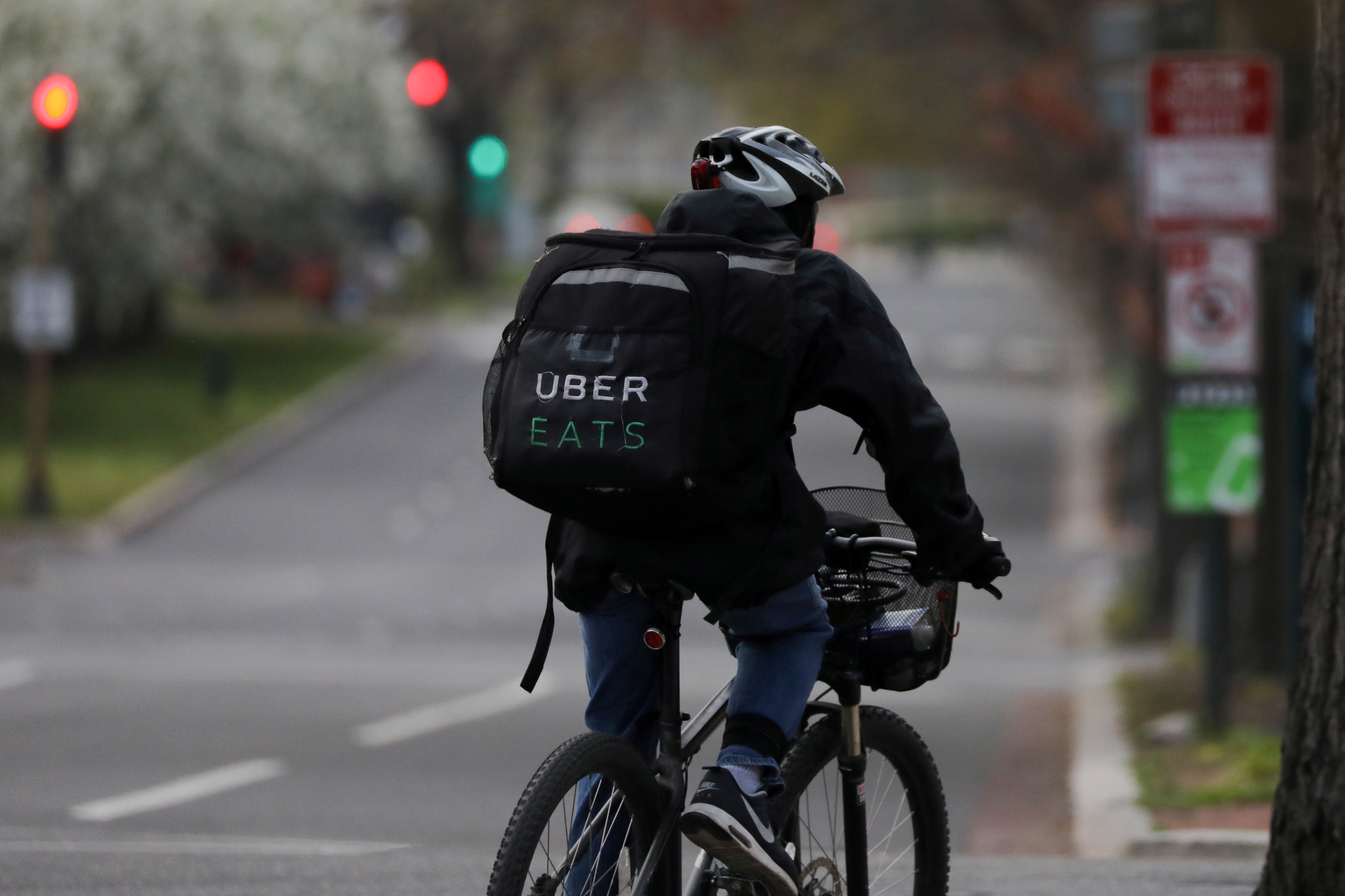 An Uber Eats bicyclist makes a delivery during the coronavirus outbreak, in the U.S. Capitol Hill neighborhood in Washington