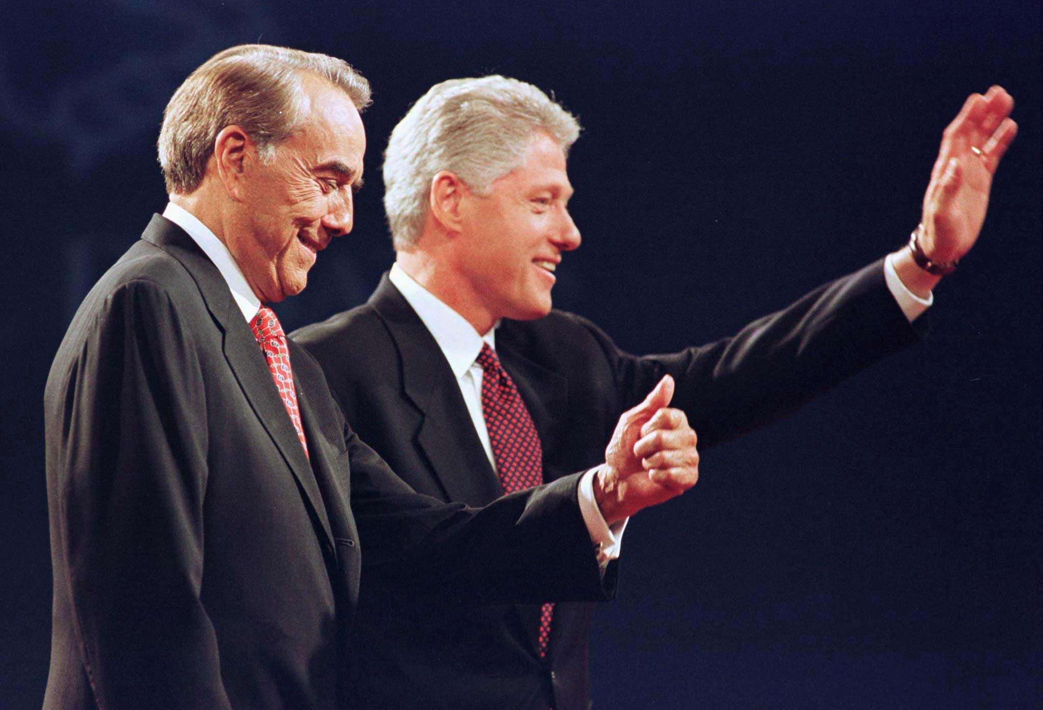 Republican presidential nominee Bob Dole (L) gives a thumb up as President Bill Clinton waves to the audience following the first presidential debate in Hartford, Connecticut, Oct. 6, 1997. REUTERS/File Photo