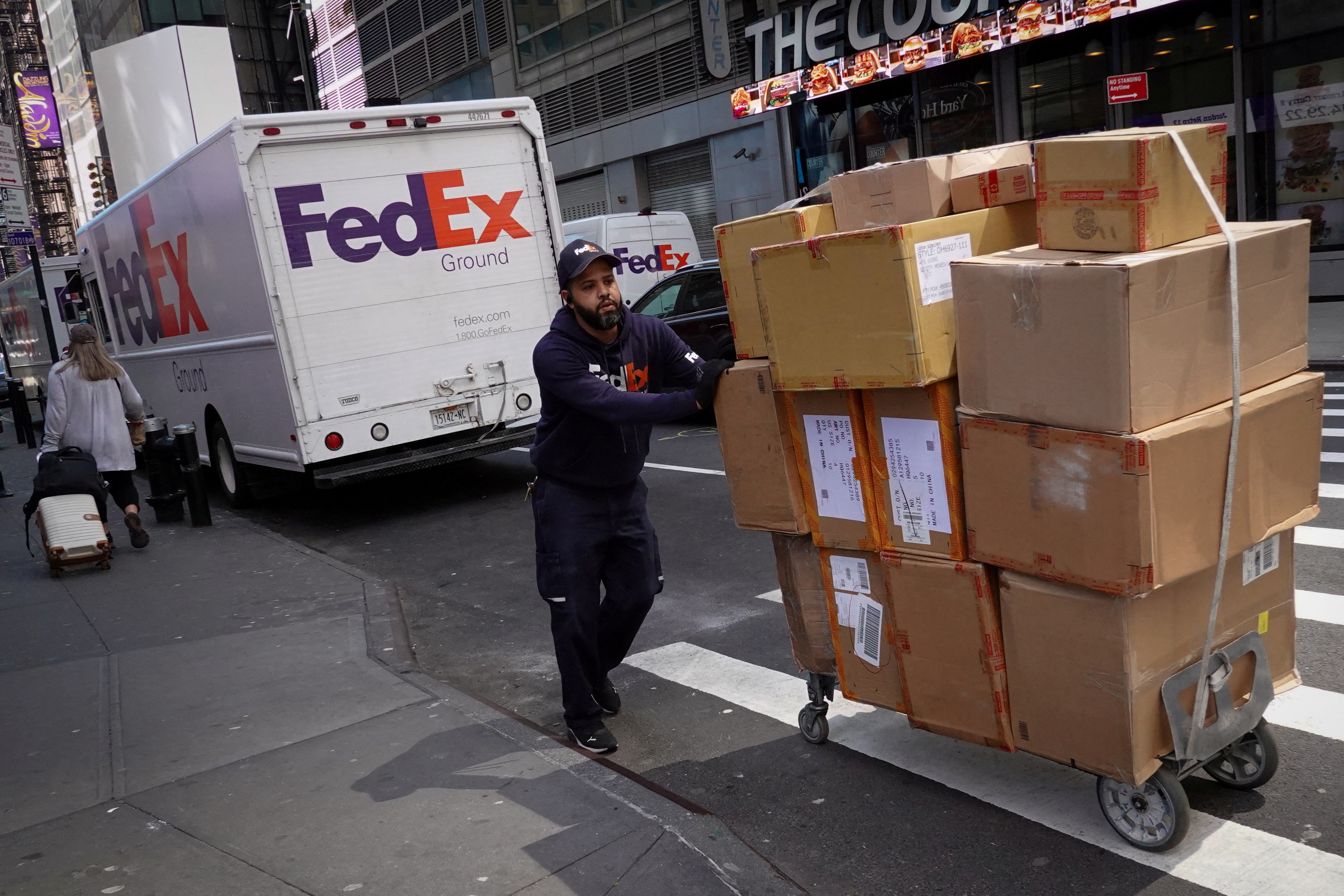 A FedEx worker delivers packages in Manhattan, New York City