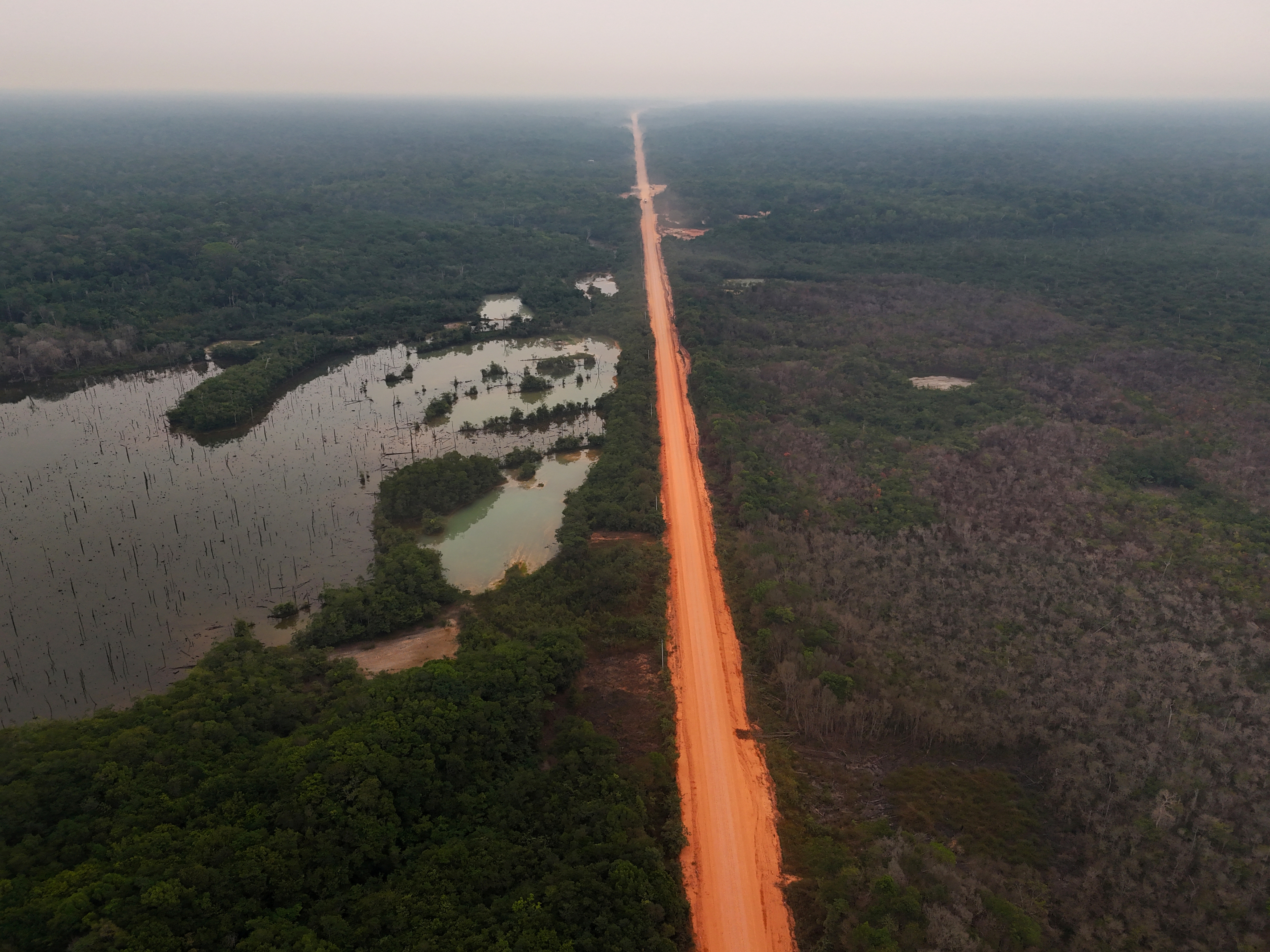 A drone view shows amazon forest surrounding the BR 319 highway in Amazonas state