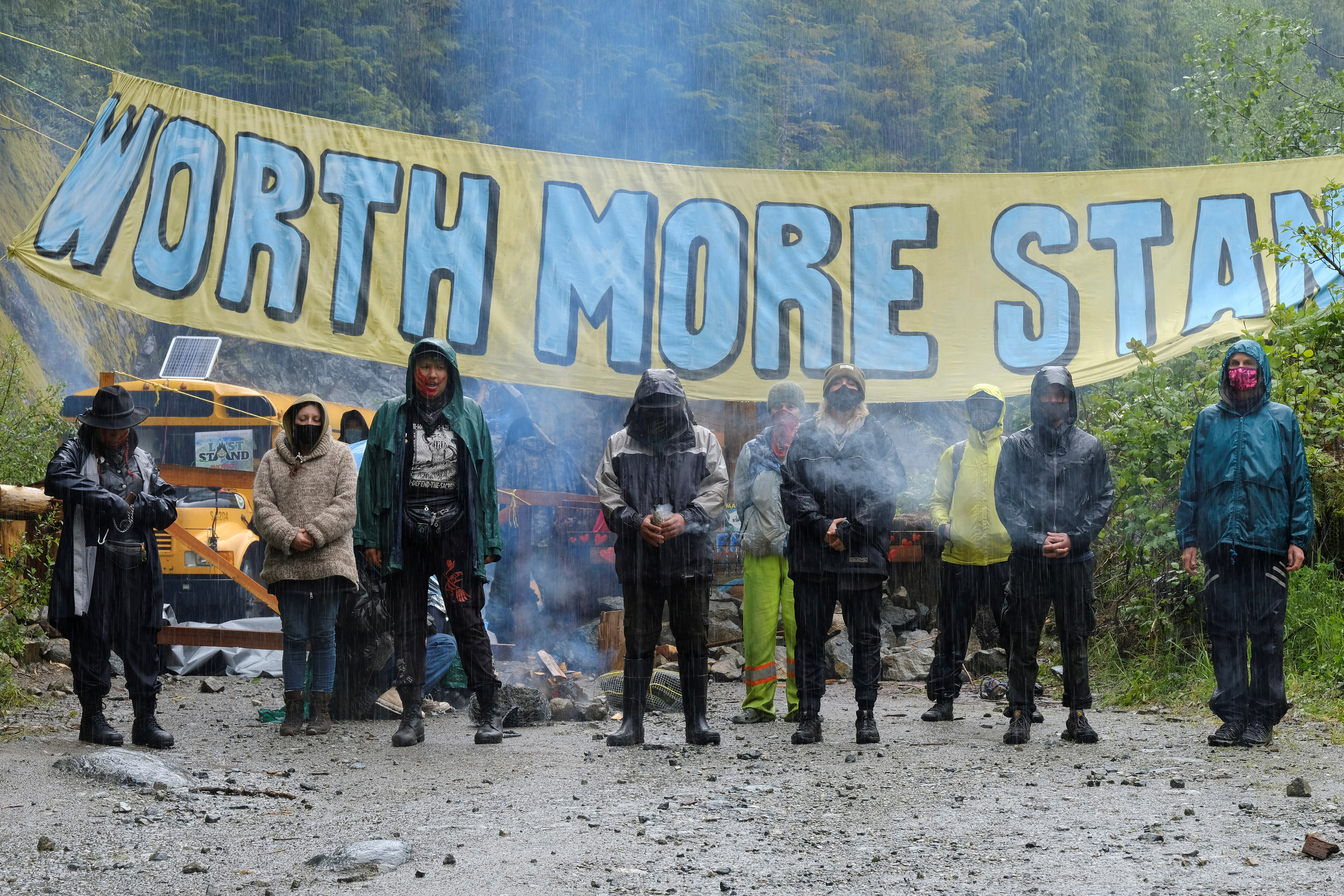 Activists stand at a blockade at Waterfall camp in the Fairy Creek area of Vancouver Island