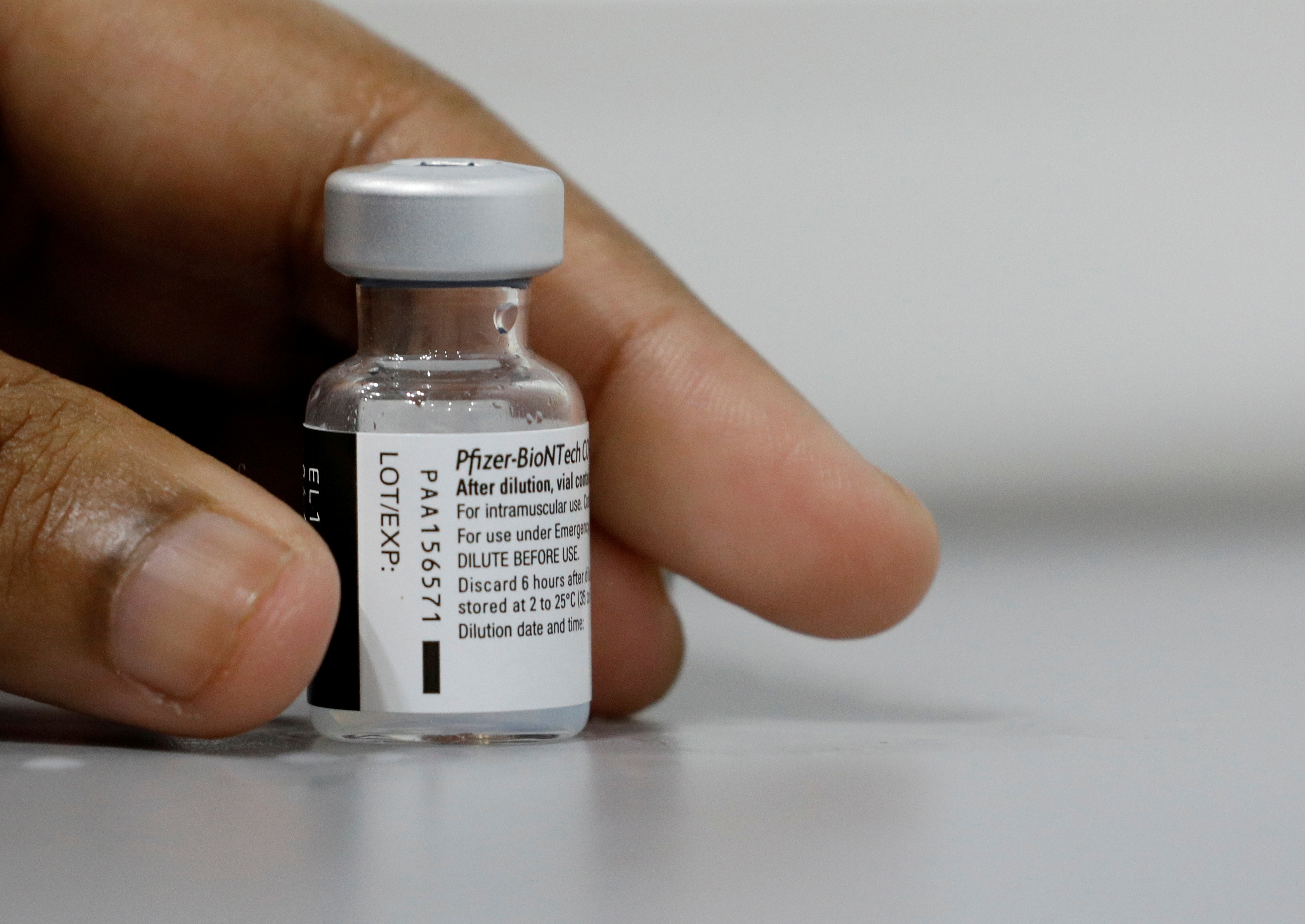 A medical worker prepares to dilute a vial of Pfizer-BioNTech vaccine at a coronavirus disease (COVID-19) vaccination center in Singapore