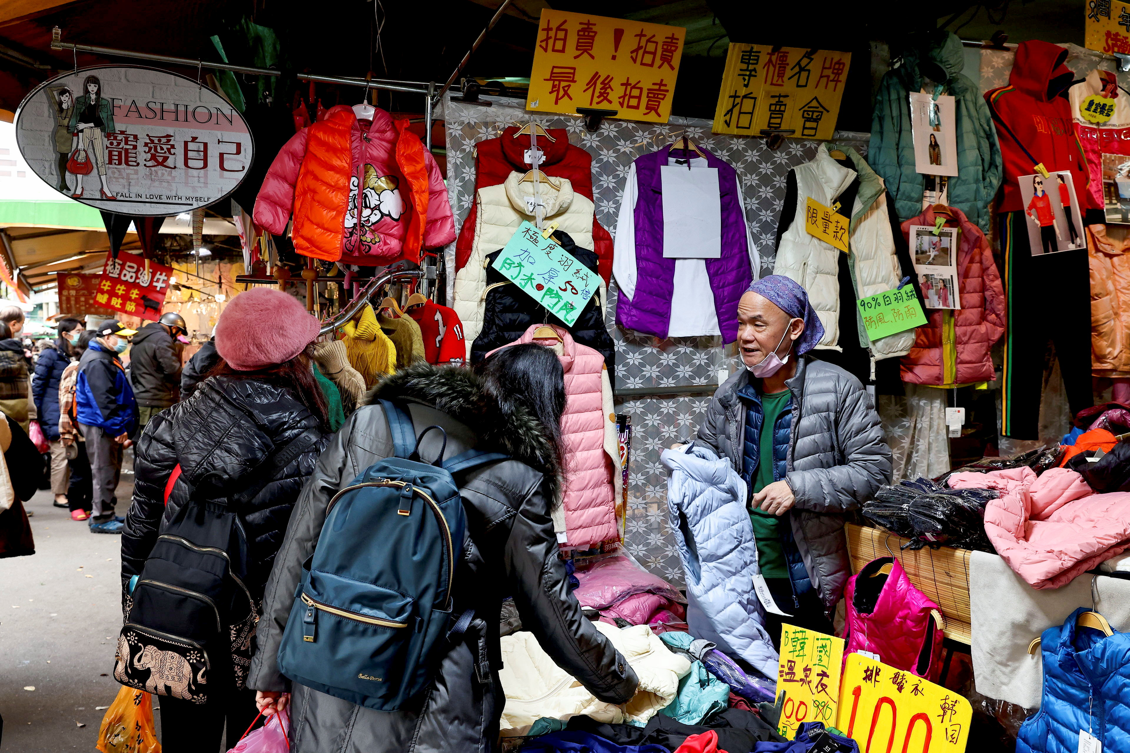 People buy winter jackets at a market in Taipei
