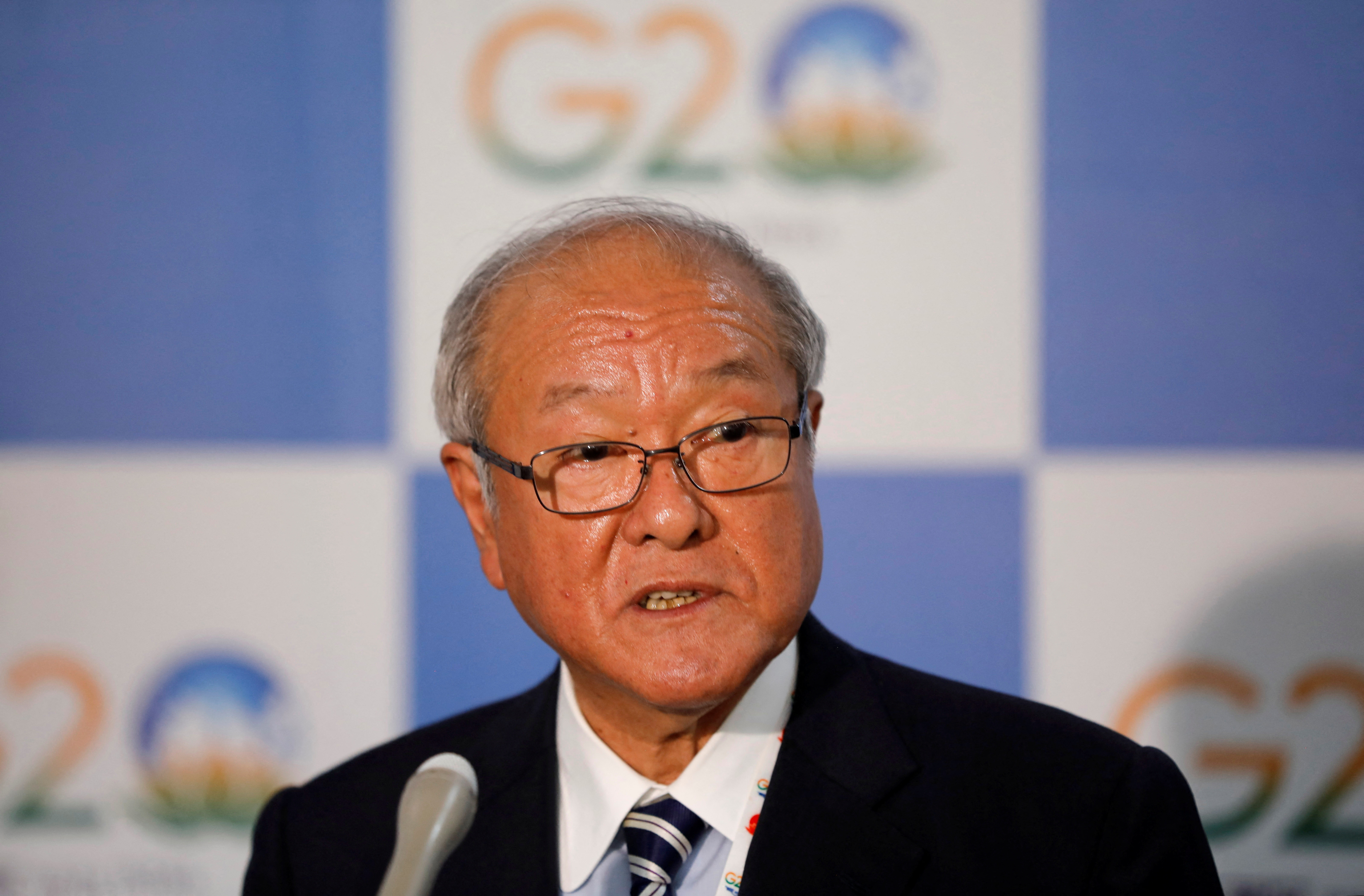 Japanese Finance Minister Shunichi Suzuki speaks with the media after a meeting of G7 leaders, at Gandhinagar