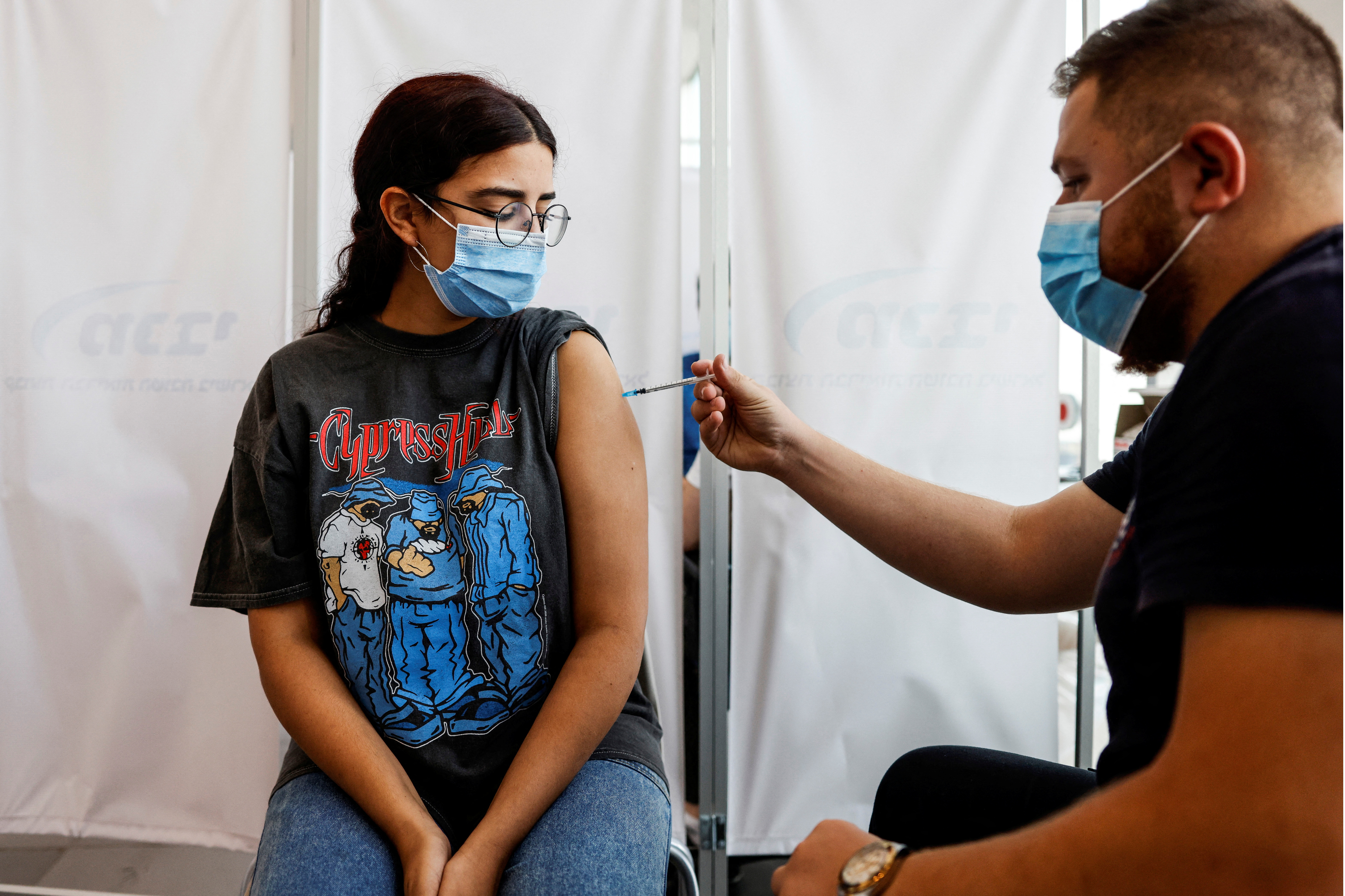An Israeli woman receives a third shot of coronavirus disease (COVID-19) vaccine in Tel Aviv