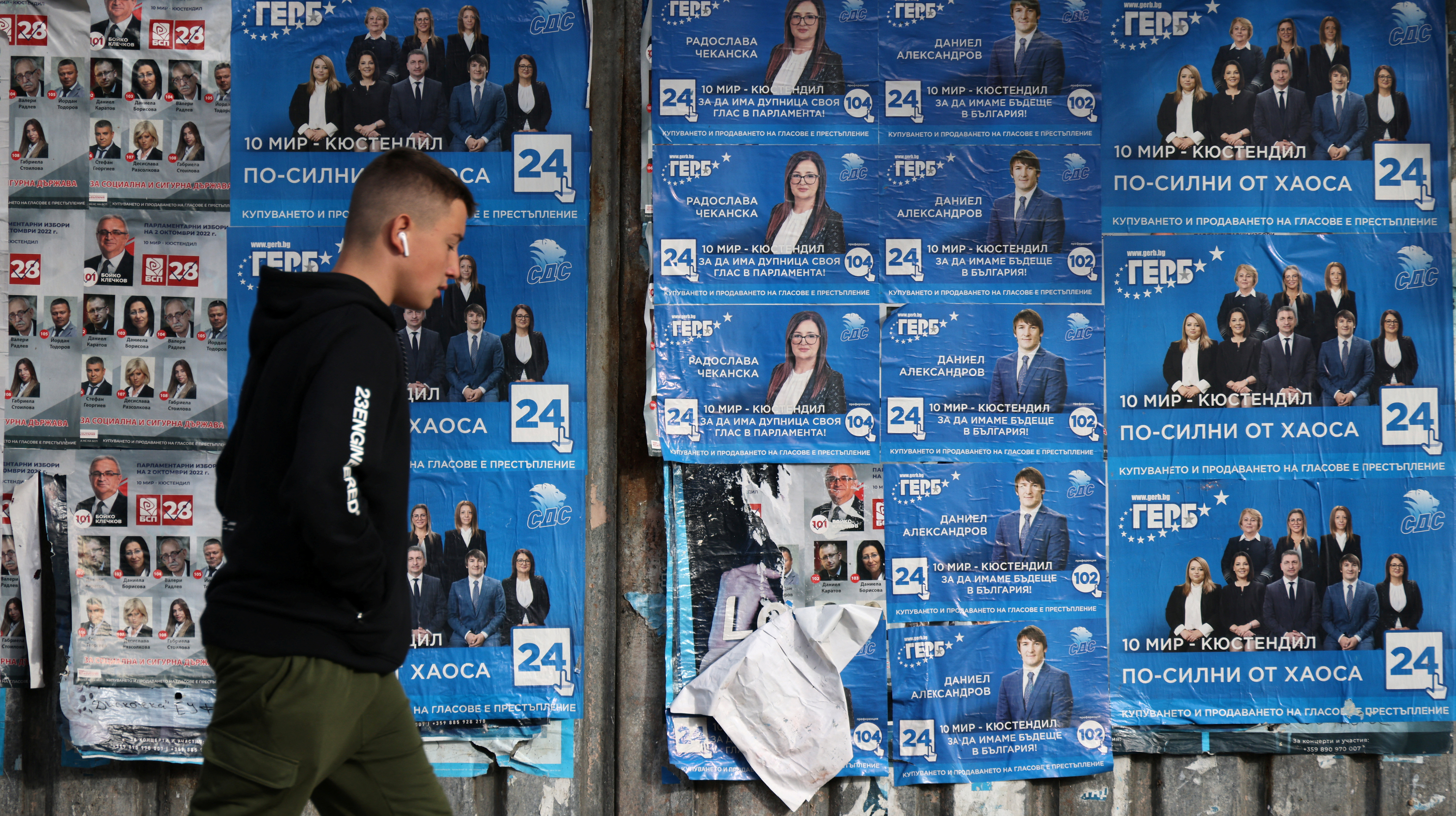Man walks past election posters of centre-right GERB party in the town of Dupnitsa
