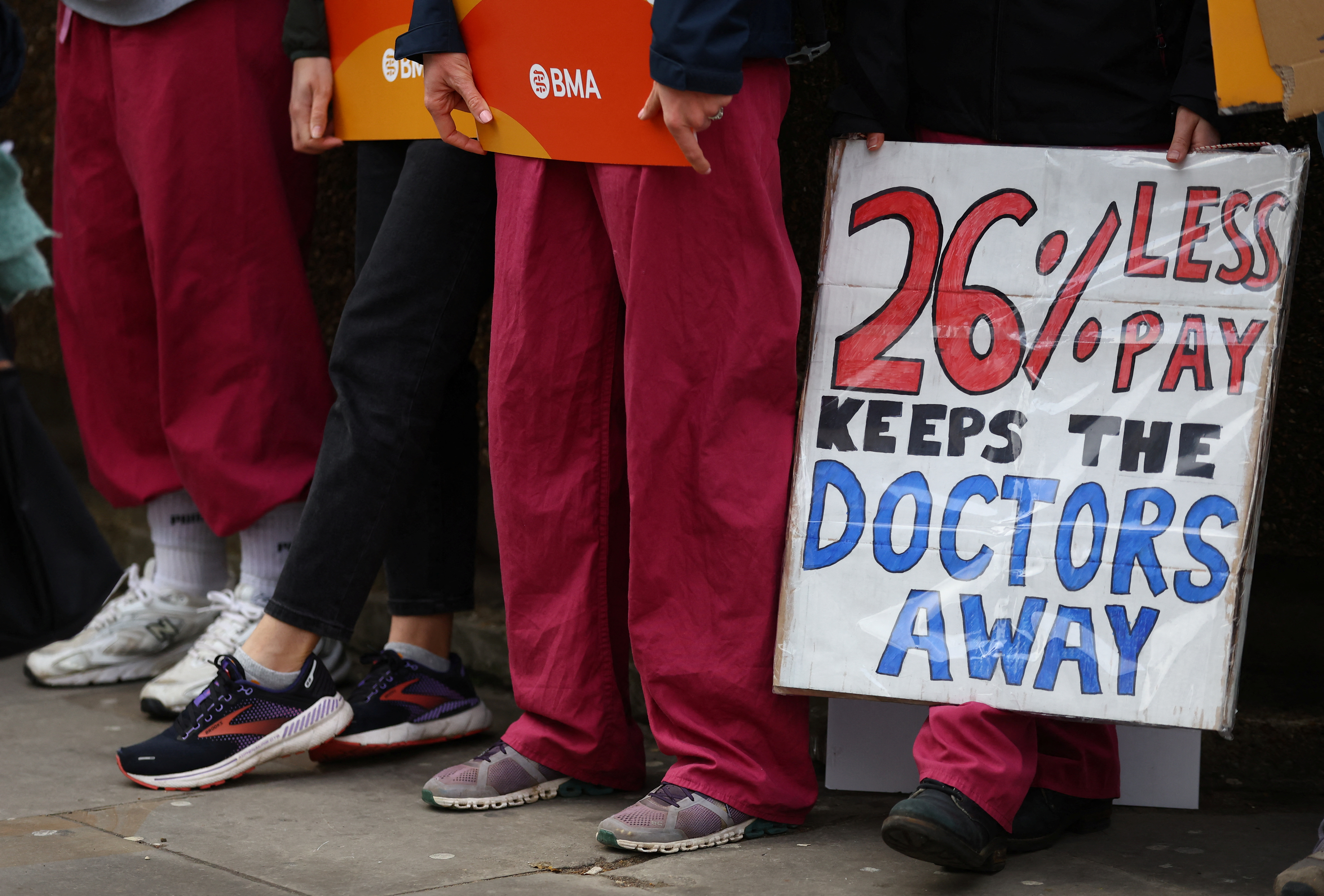 People attend a protest by junior doctors in London