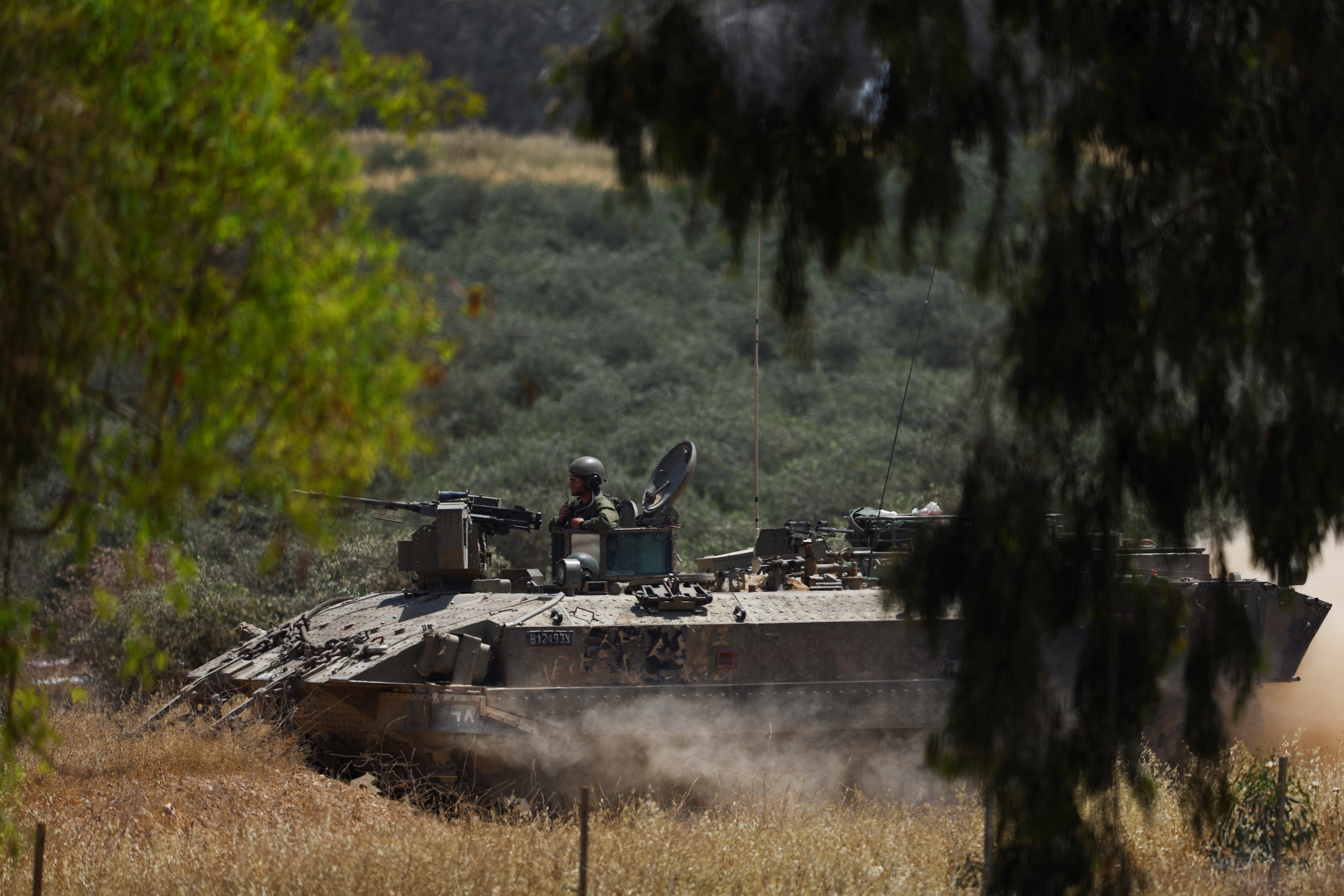 An Israeli soldier sits in a military vehicle near Israel's border with Gaza