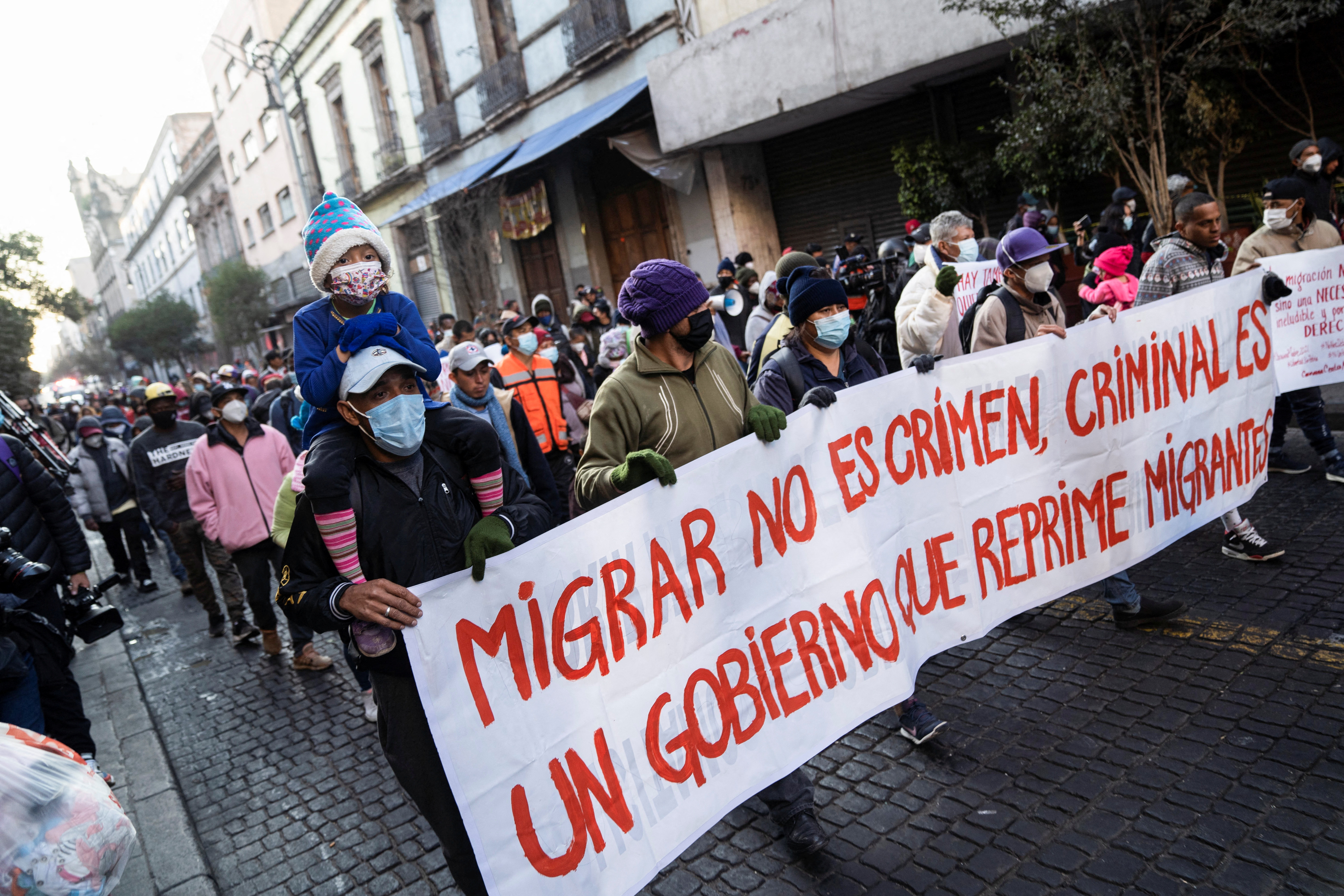 Migrants hold a protest under the slogan 