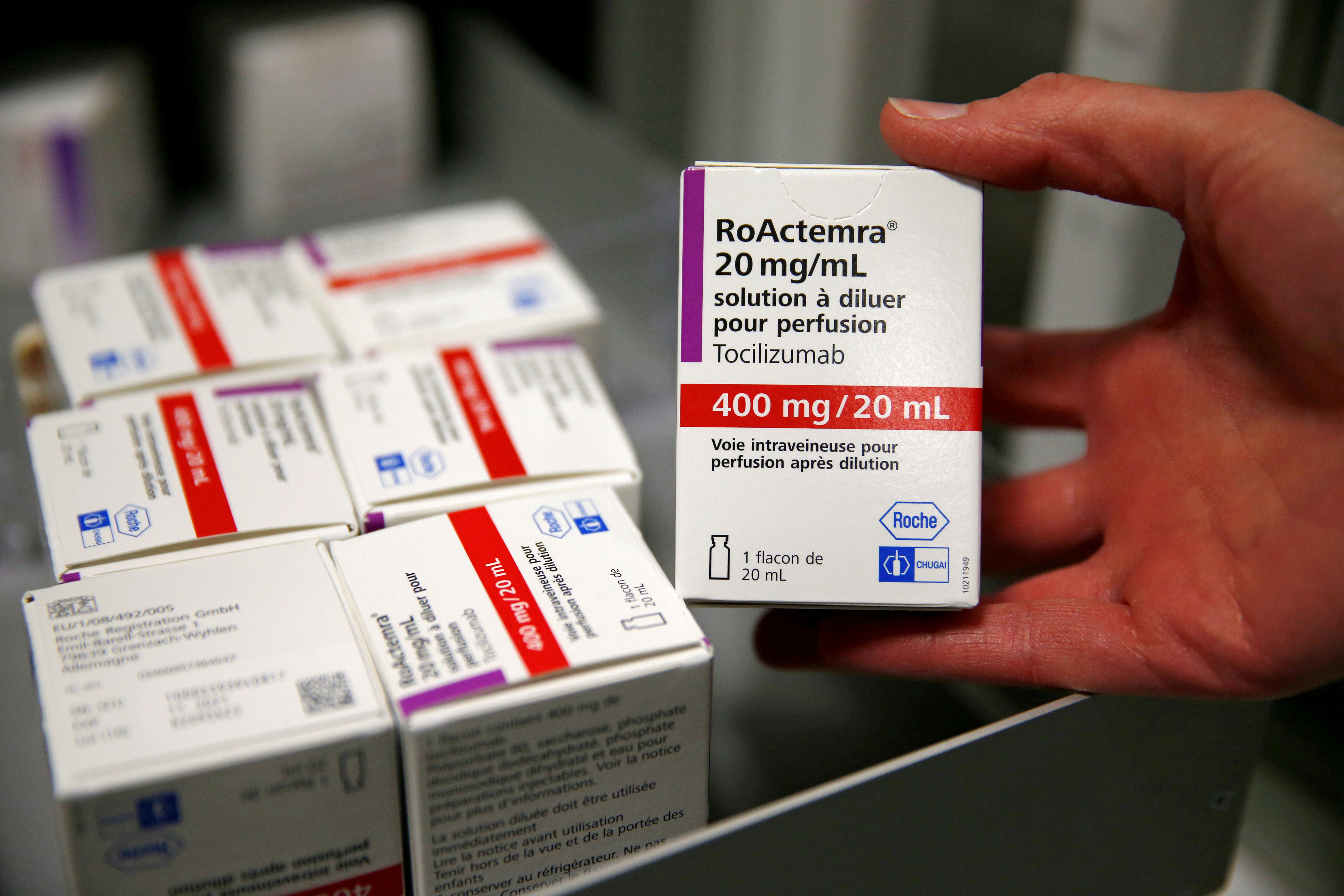 A pharmacist displays a box of tocilizumab, which is used in the treatment of rheumatoid arthritis, at the pharmacy of Cambrai hospital, France, April 28, 2020. REUTERS/Pascal Rossignol