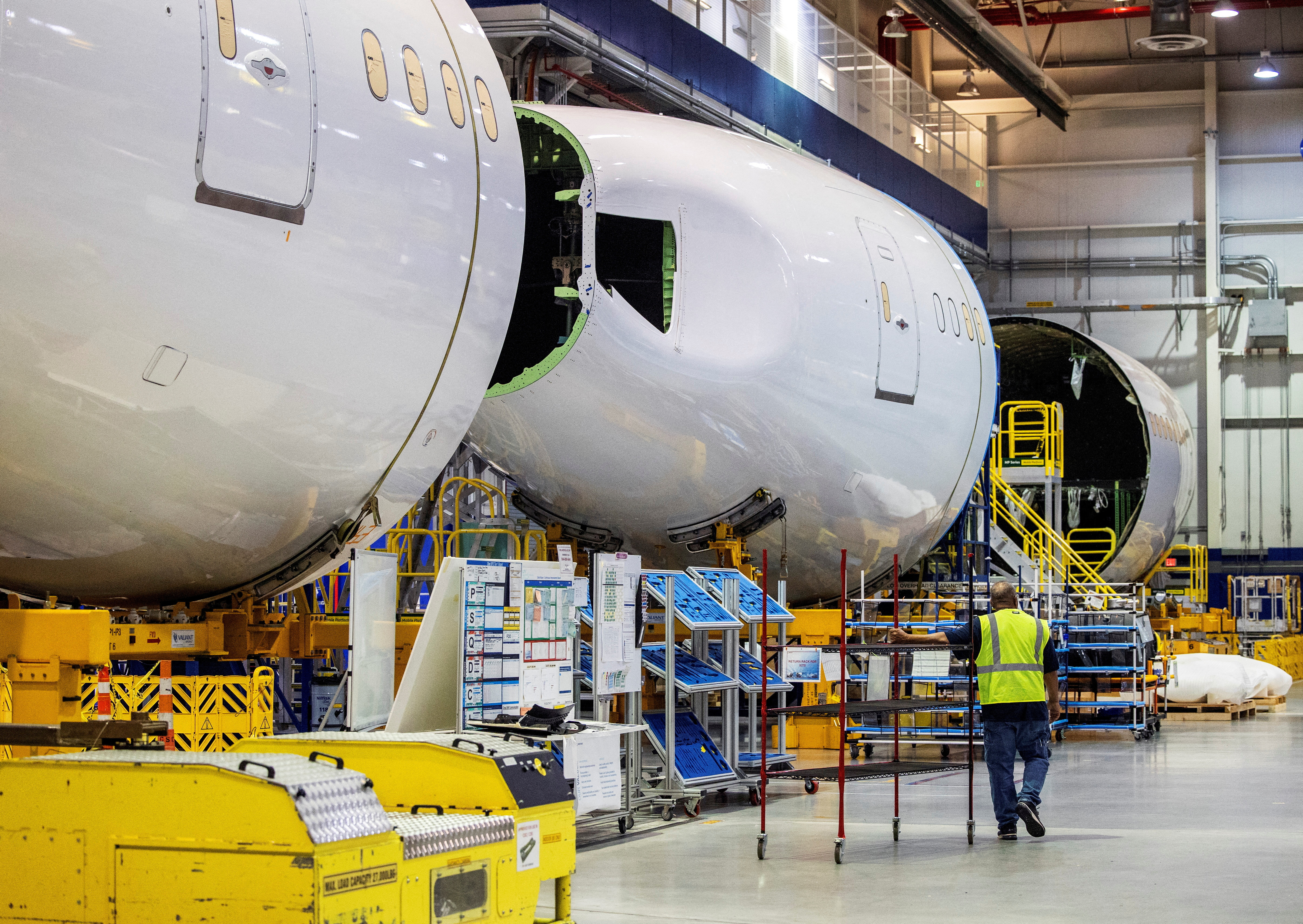 An employee walks past a fuselage section under construction at Boeing Co.'s 787 Dreamliner campus in North Charleston, South Carolina