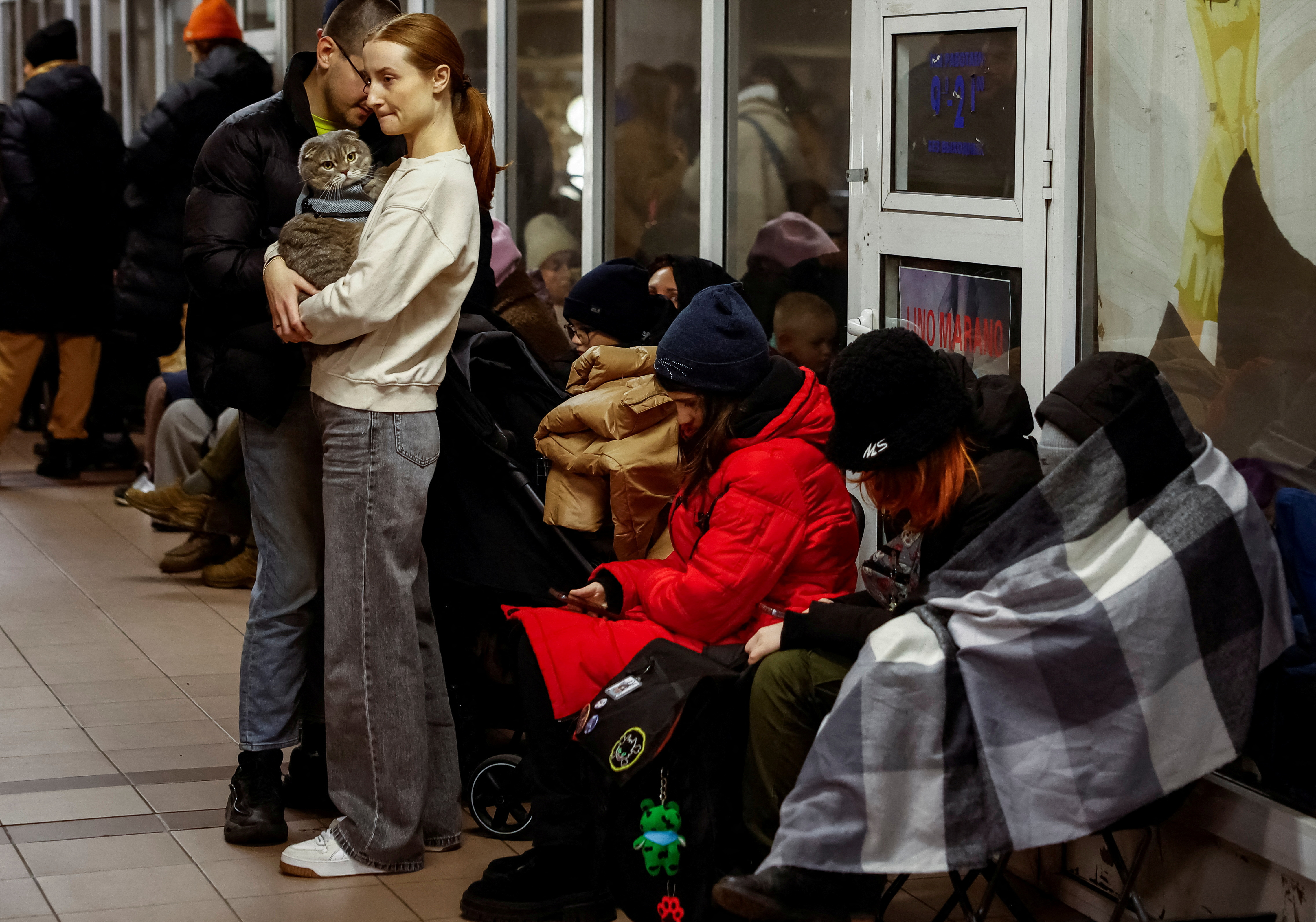 People take shelter inside a metro station during a Russian military attack, in Kyiv