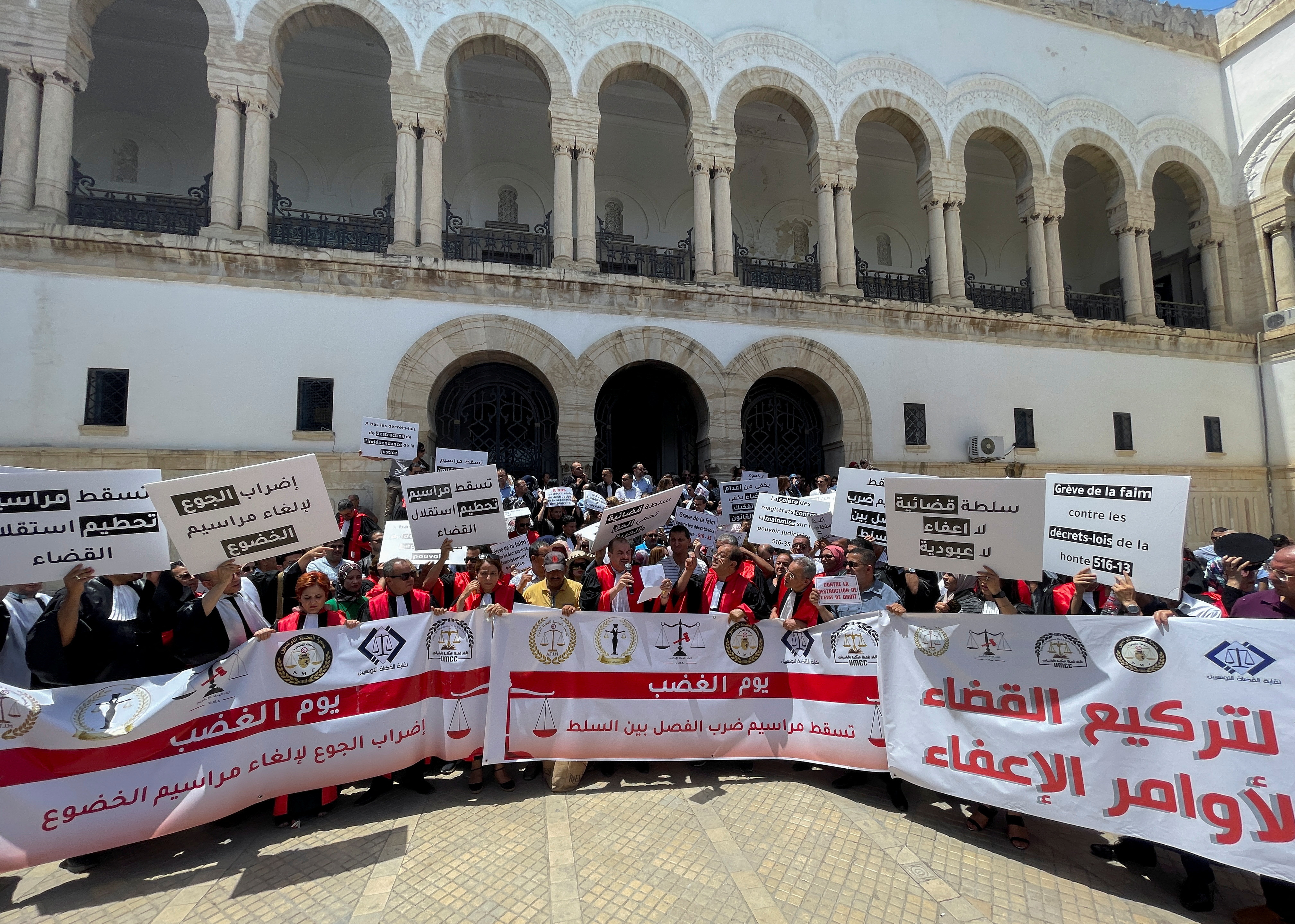 Tunisian judges carry banners during a protest in Tunis