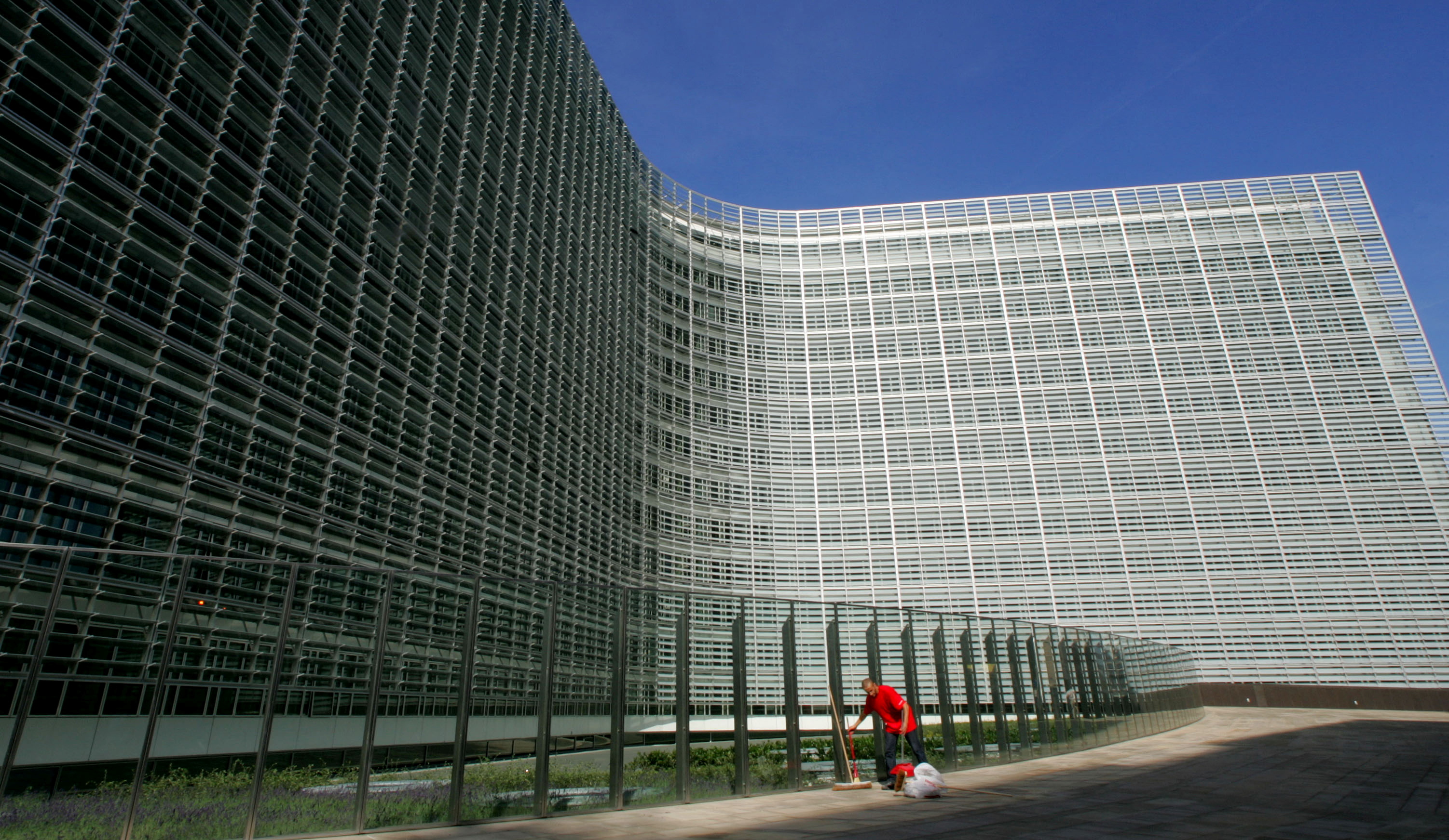 A worker cleans outside the future headquarters of the European Commission in Brussels.