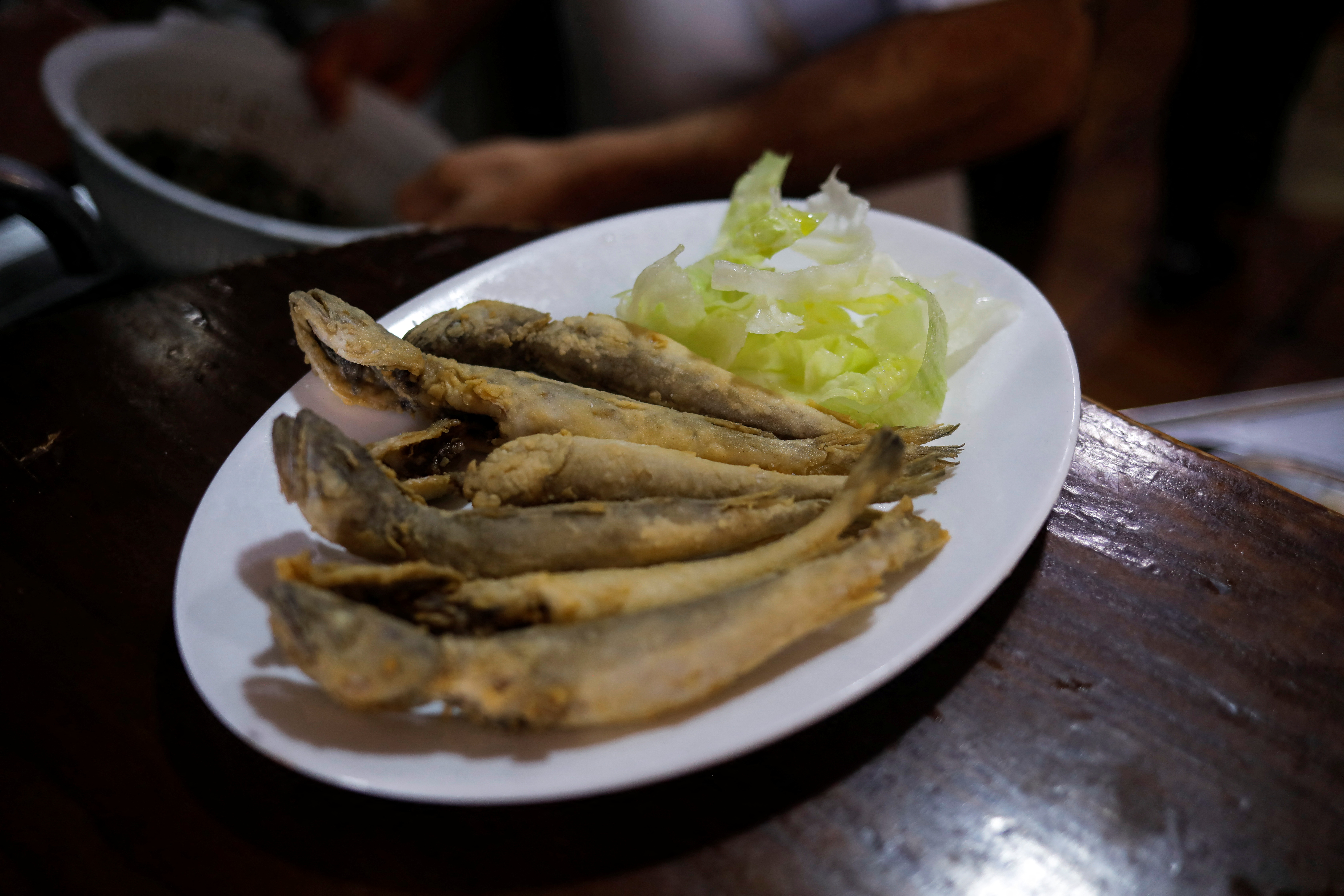 Fish fried cooked with sunflower oil are seen on a plate at Los Cazadores bar in Ronda