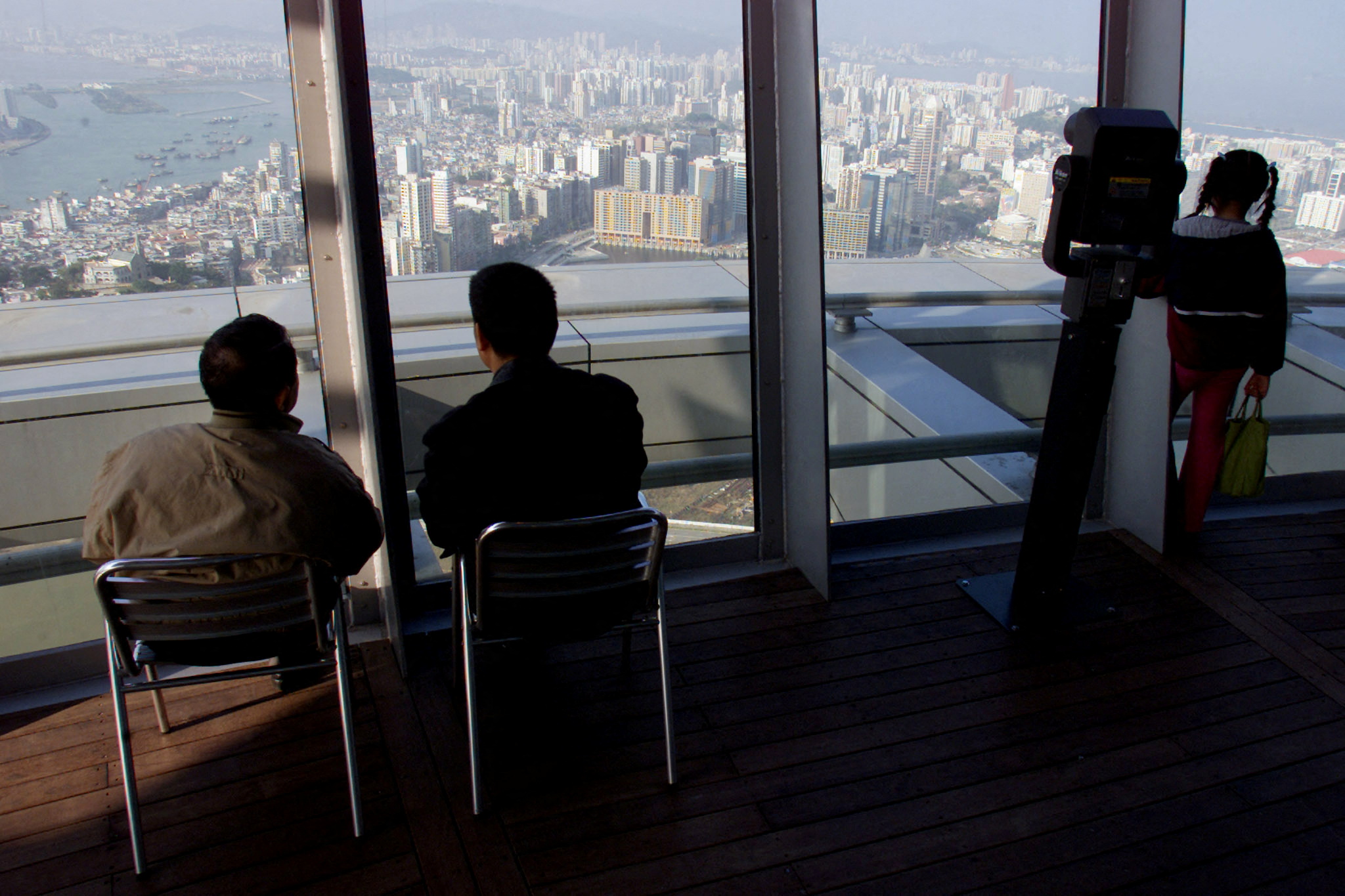 VISITORS OBSERVE AN OVERVIEW FROM MACAU TOWER.