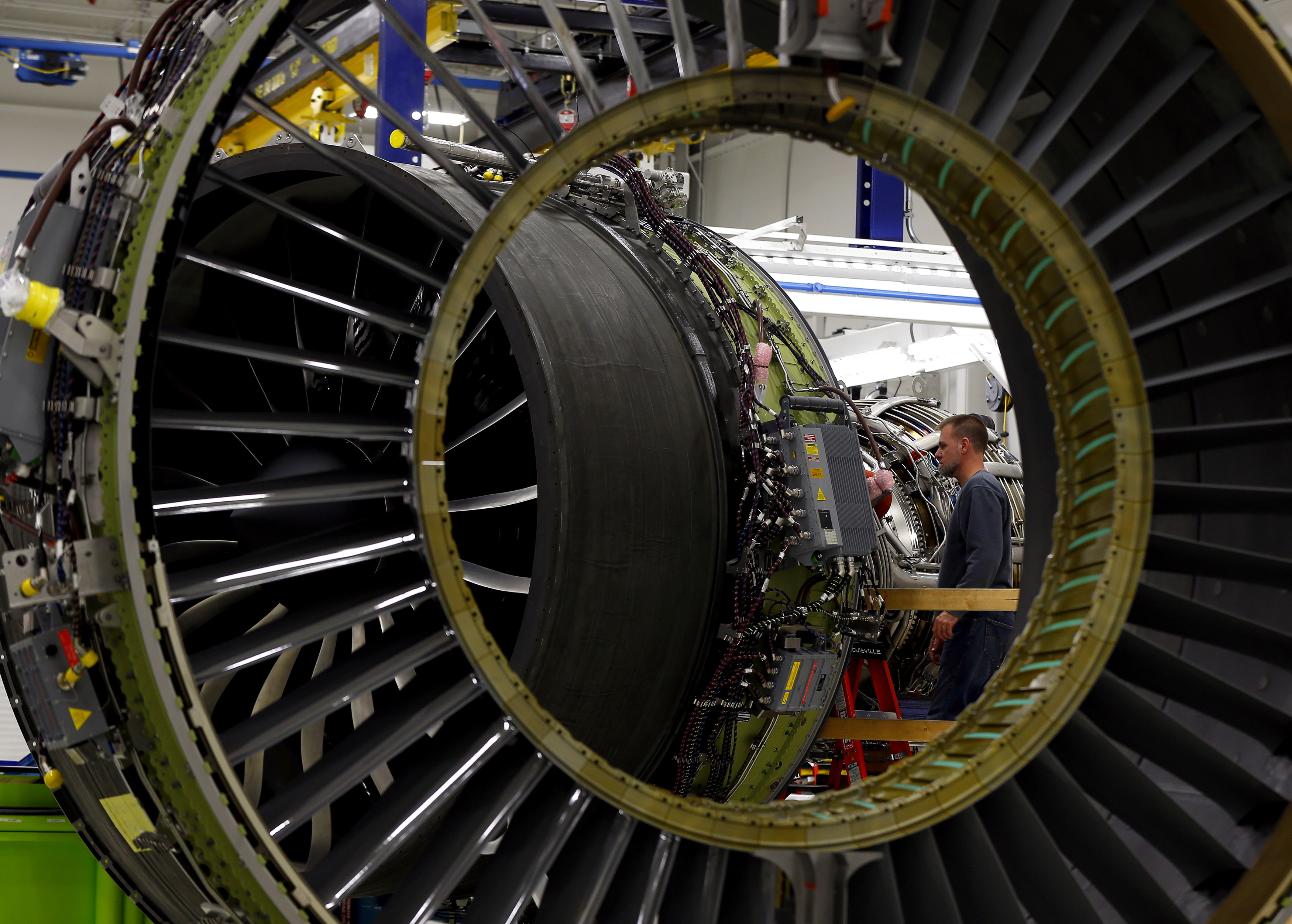 A General Electric employee inspects a jet engine at the GE Aviation Peebles Test Operations Facility in Peebles, Ohio